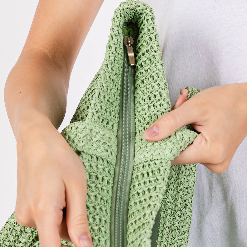 Solid crochet straw tote bag, beach handbag by Private Label with woven design and sturdy handles for casual summer use.