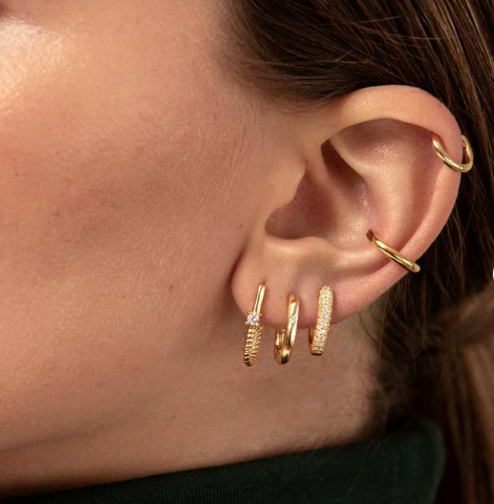 14K gold Roped In huggie hoop earrings featuring a sleek steel design, perfect for everyday wear.