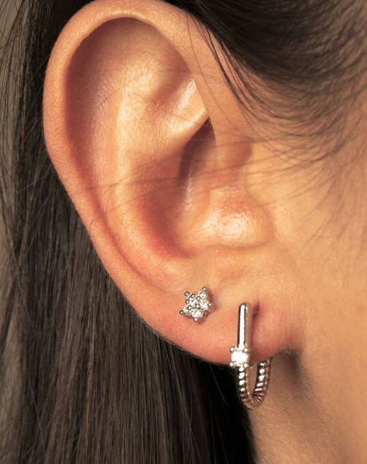 Roped In 14K Gold huggie hoop earrings in steel, showcasing a stylish twisted design and polished finish.