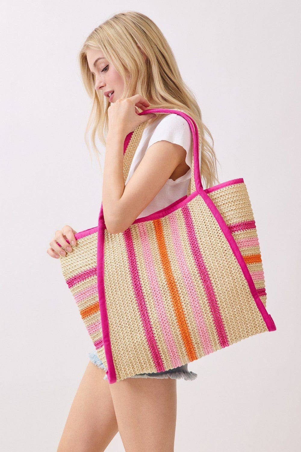 Multi-color straw beach tote bag by Private Label featuring a spacious design and sturdy handles for beach outings.