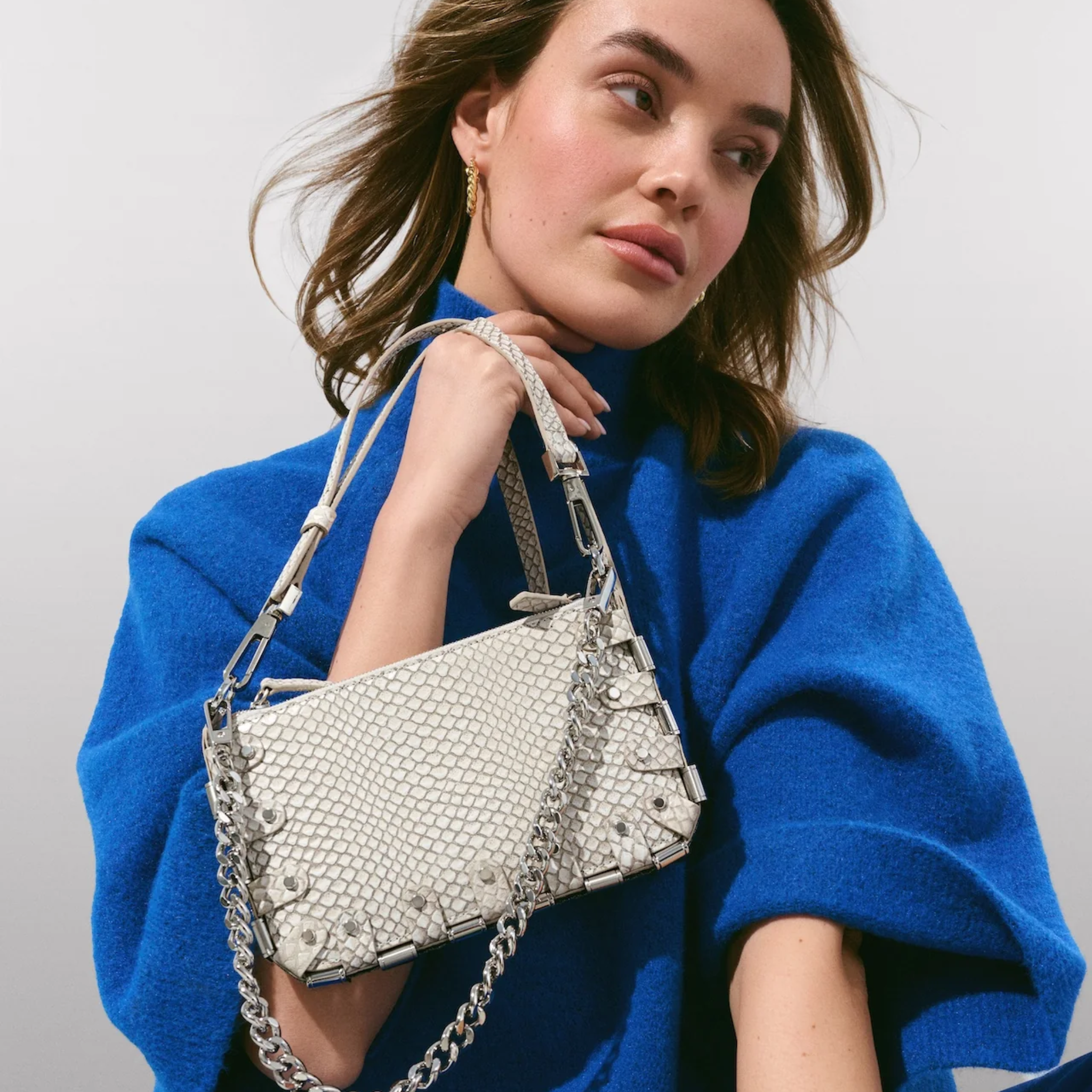Black RAPT The Rapture Crossbody Bag with adjustable strap and sleek design, shown on a plain background.