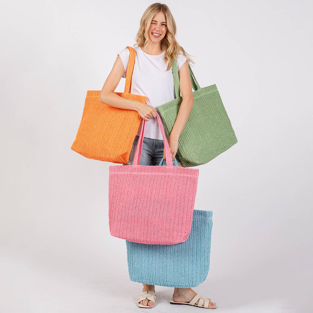Solid crochet straw tote bag with handles, perfect as a beach or casual handbag, by private label.