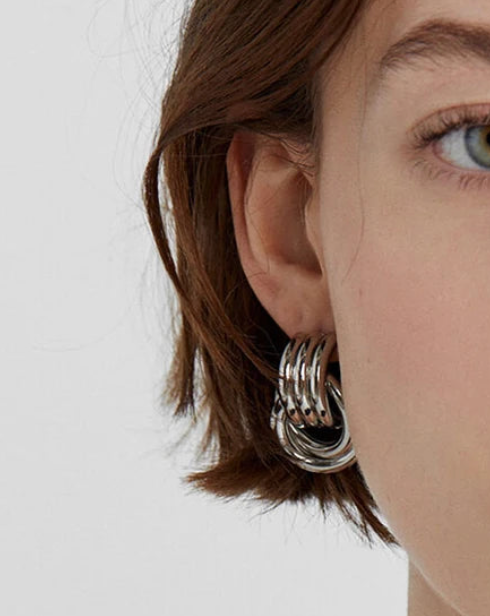 Two-tone double knotted door knocker earrings with a stylish design by Private Label, showcased against a neutral background.
