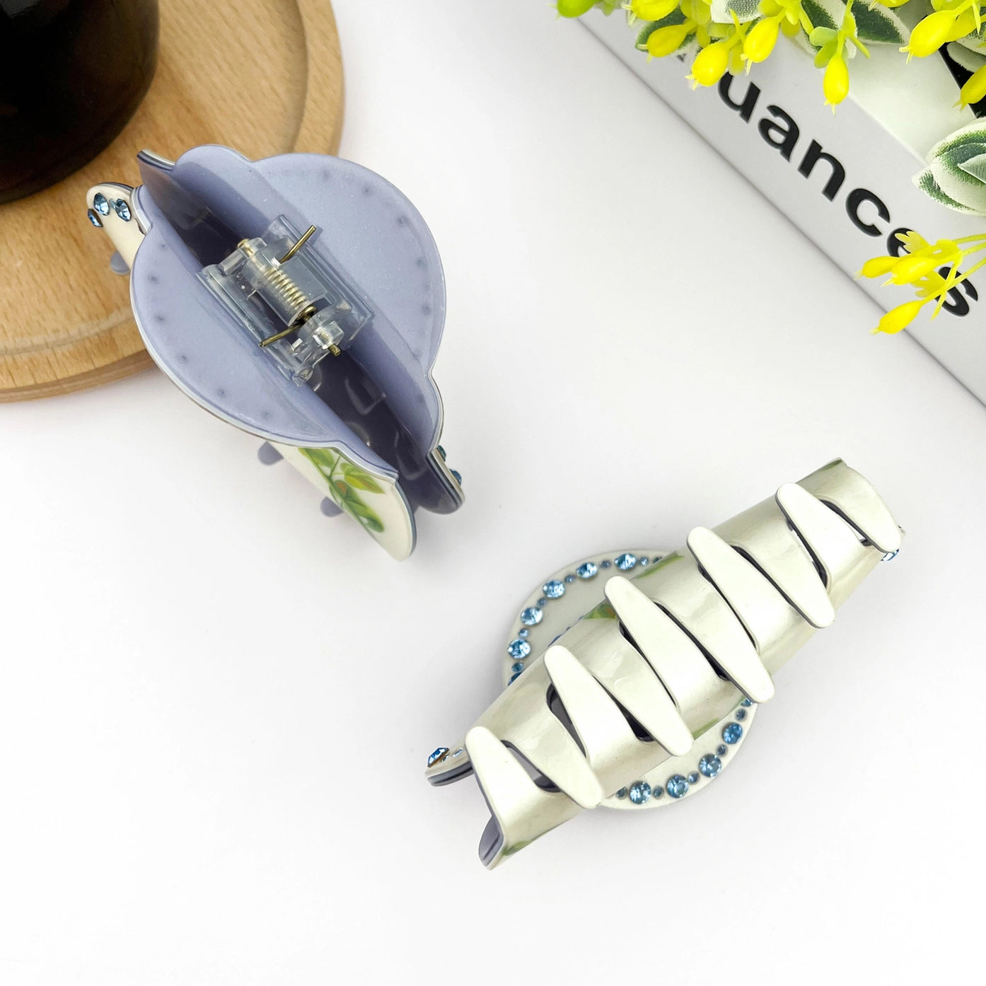Blue rose claw clip with elegant half-round design and rhinestones, perfect for securing hair in style.