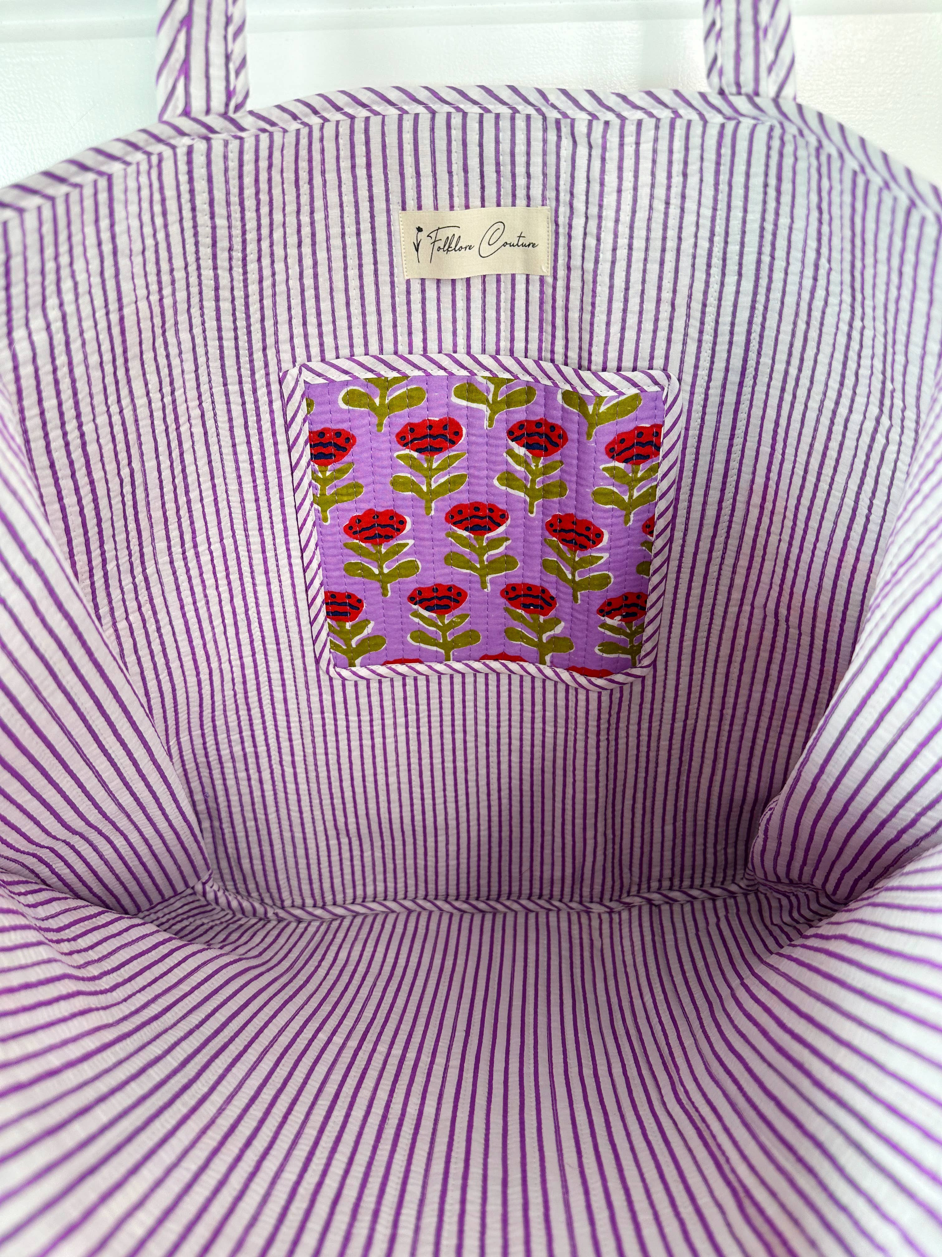 Large purple floral quilted tote bag by Folklore Couture, featuring sturdy handles and a spacious interior for shopping.
