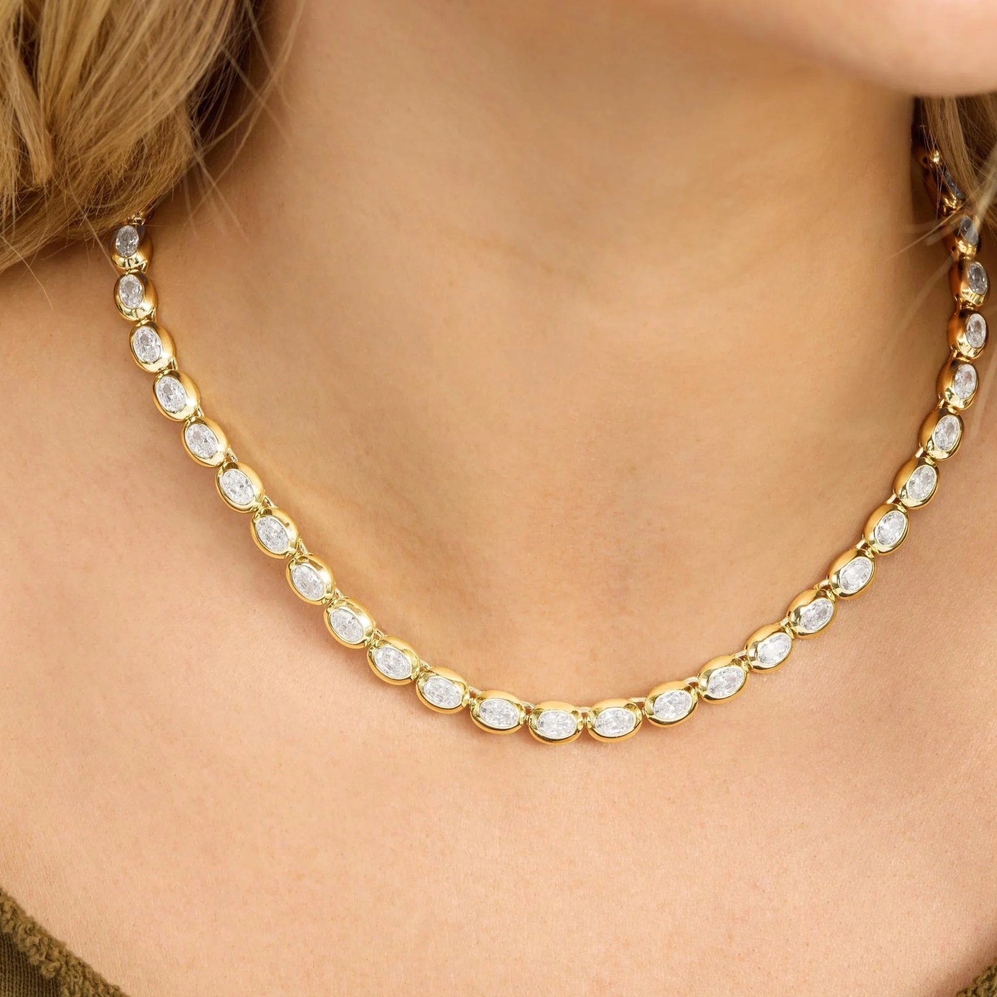Gold tennis necklace with white diamondettes, featuring the phrase "She's a Boss," by Melinda Maria.