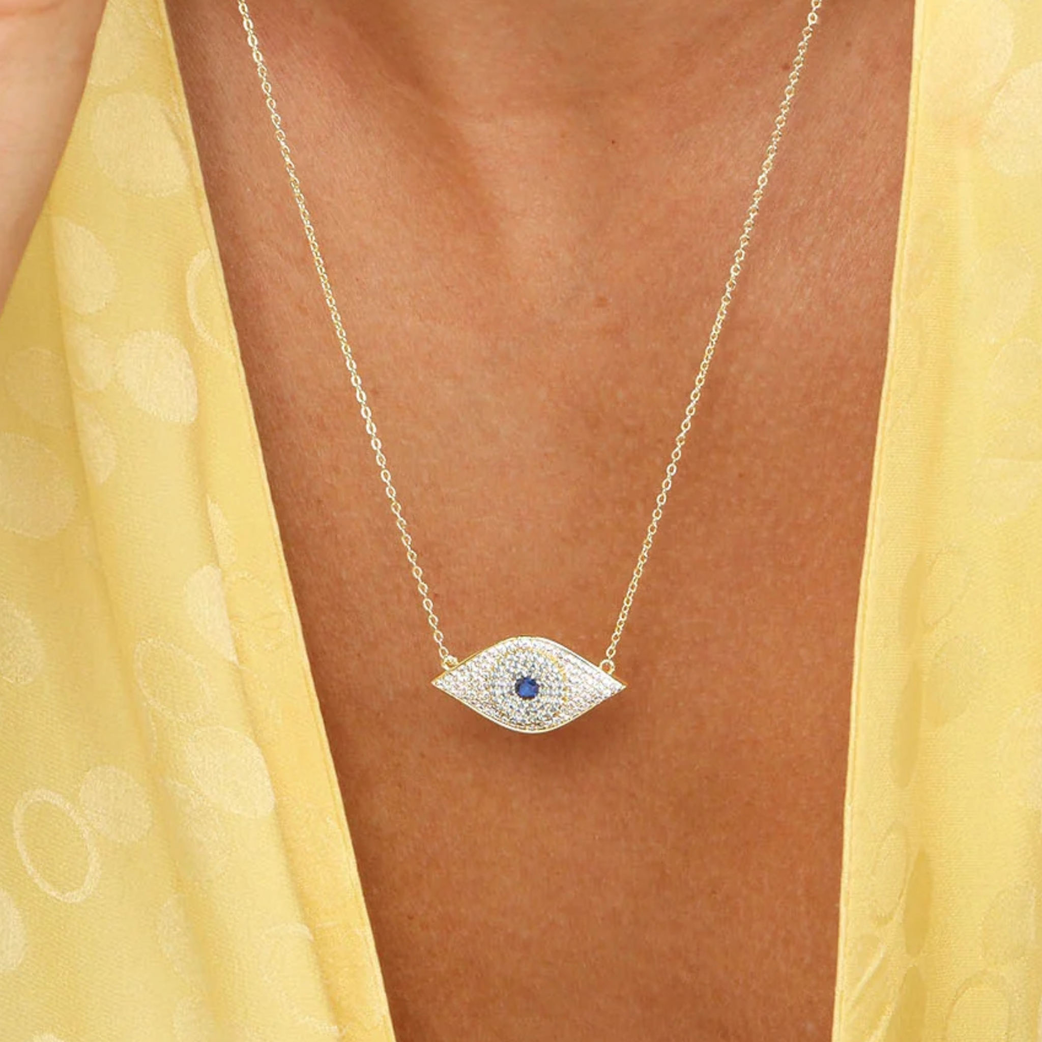 Gold Blue Evil Eye Necklace with white diamondette accents by Melinda Maria, featuring a detailed evil eye pendant.