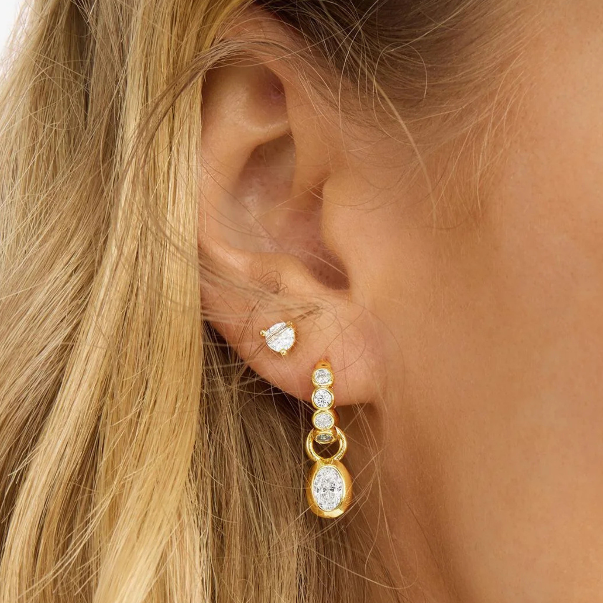 Gold and white diamondette earrings from Melinda Maria, featuring a stylish "She's a Boss" design.