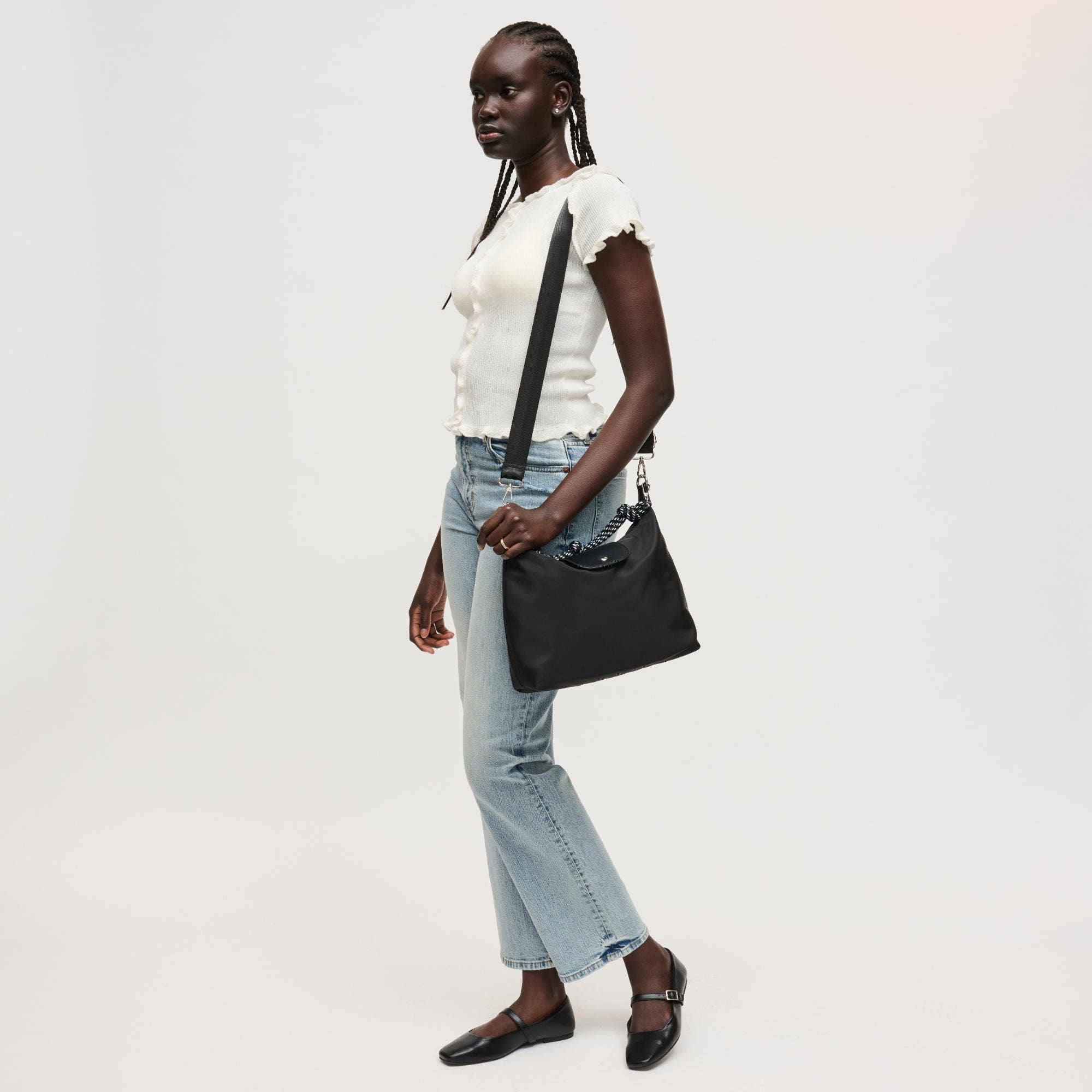 Urban Expressions Nova Hobo bag with adjustable strap and textured leather surface, stylish accessory for casual outfits.
