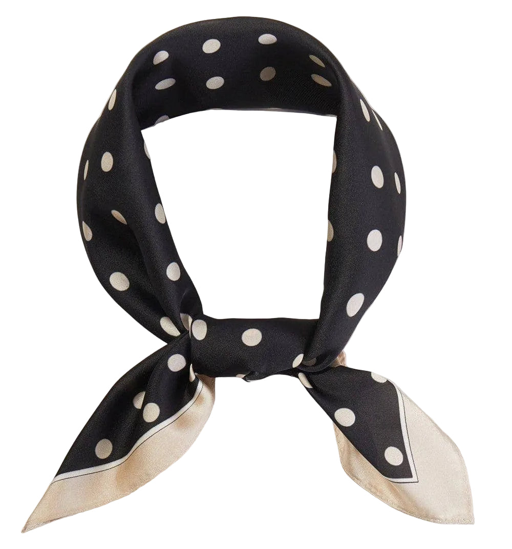 Amie polka dot print bandana in black and white, folded stylishly on a flat surface. Perfect accessory for various outfits.