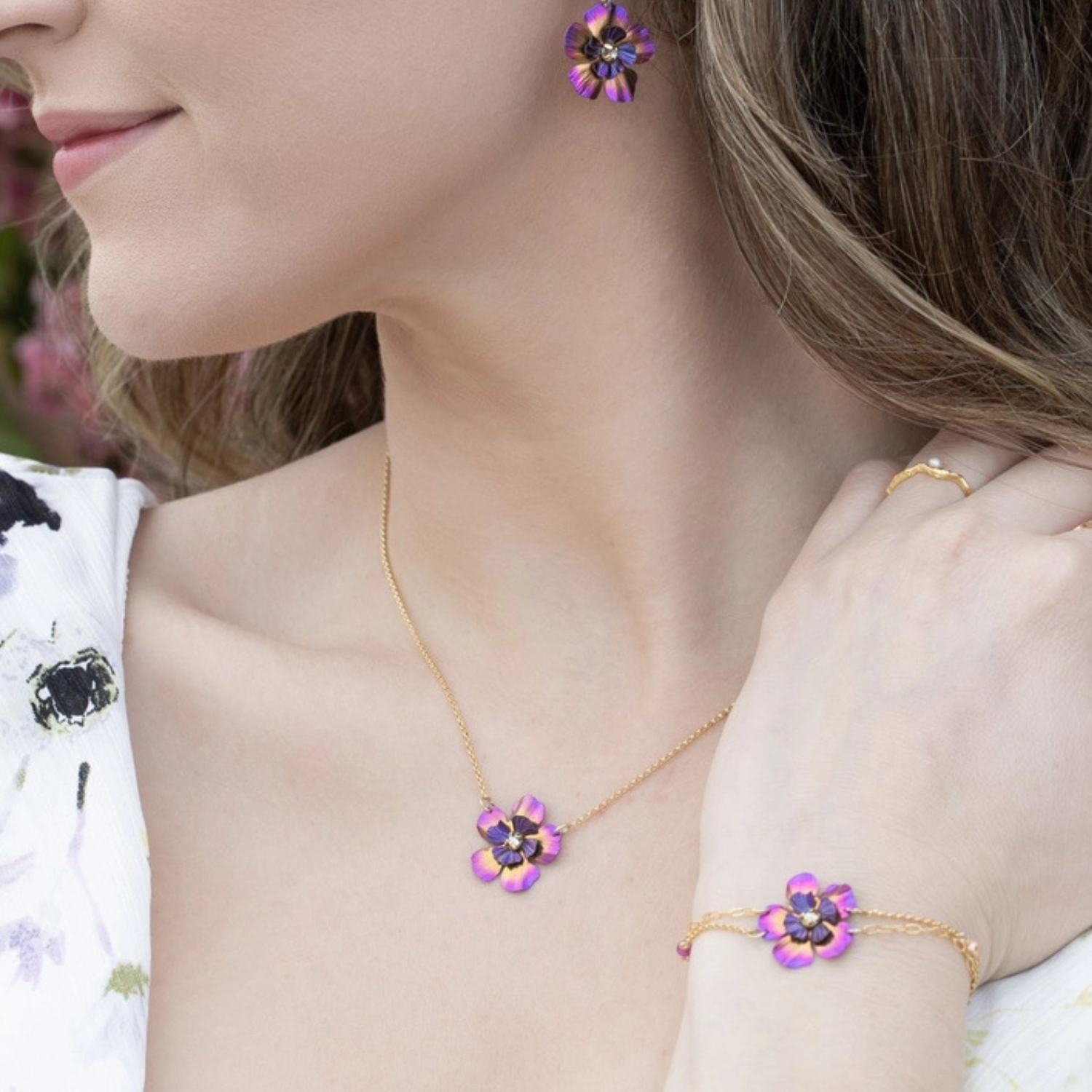 Holly Yashi Blissful Bloom pendant necklace with colorful floral design on a silver chain, close-up view.