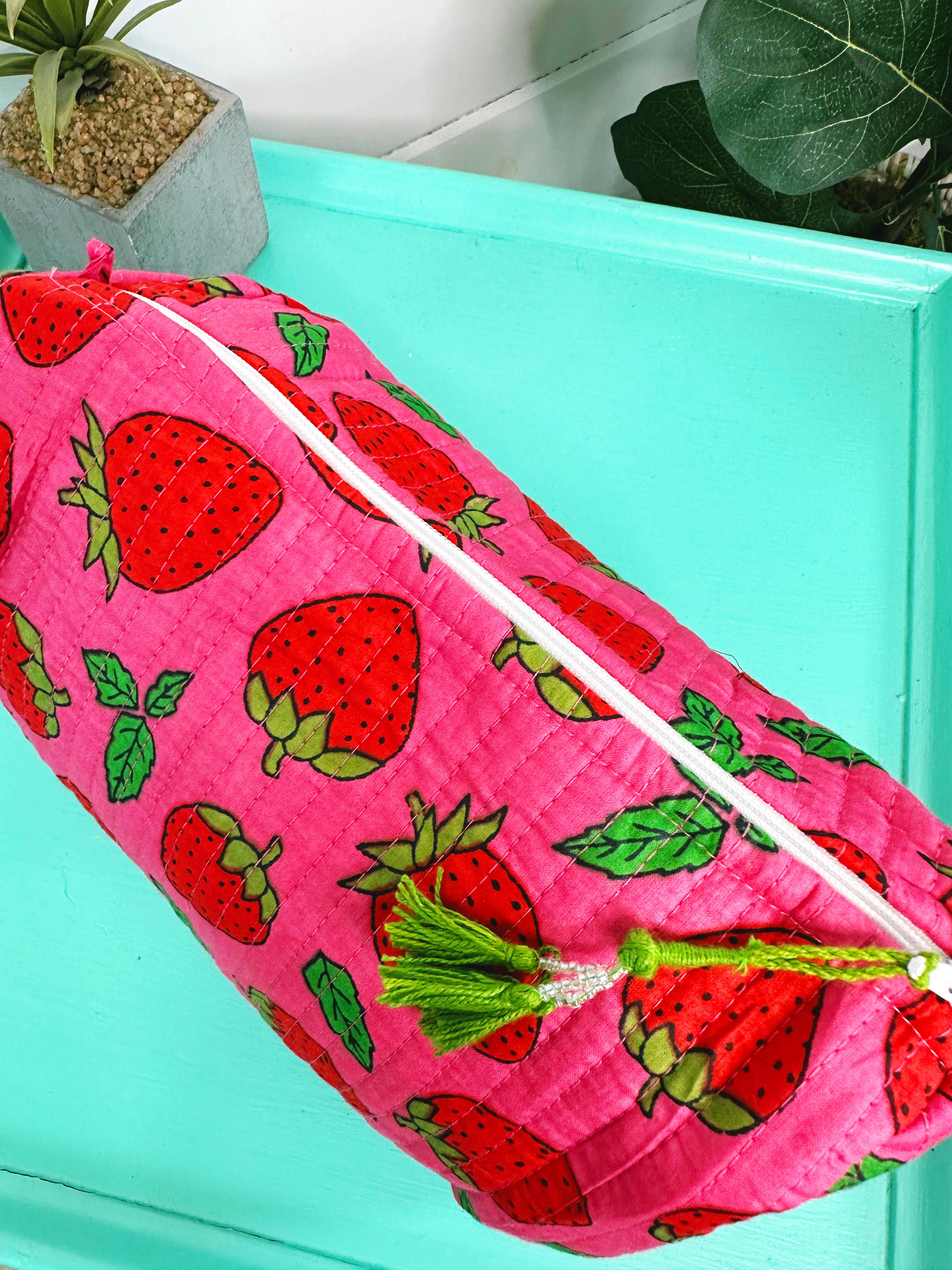 Quilted strawberry travel cosmetic bag by Folklore Couture, featuring a stylish design and spacious pouch for makeup essentials.