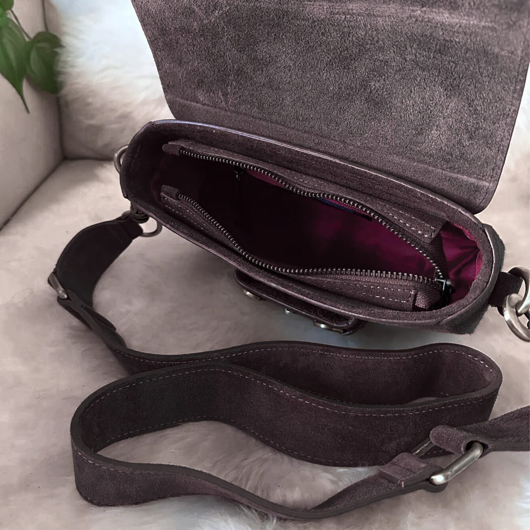 Private label Emily suede crossbody handbag with adjustable strap and gold-tone hardware, featuring a sleek, stylish design.