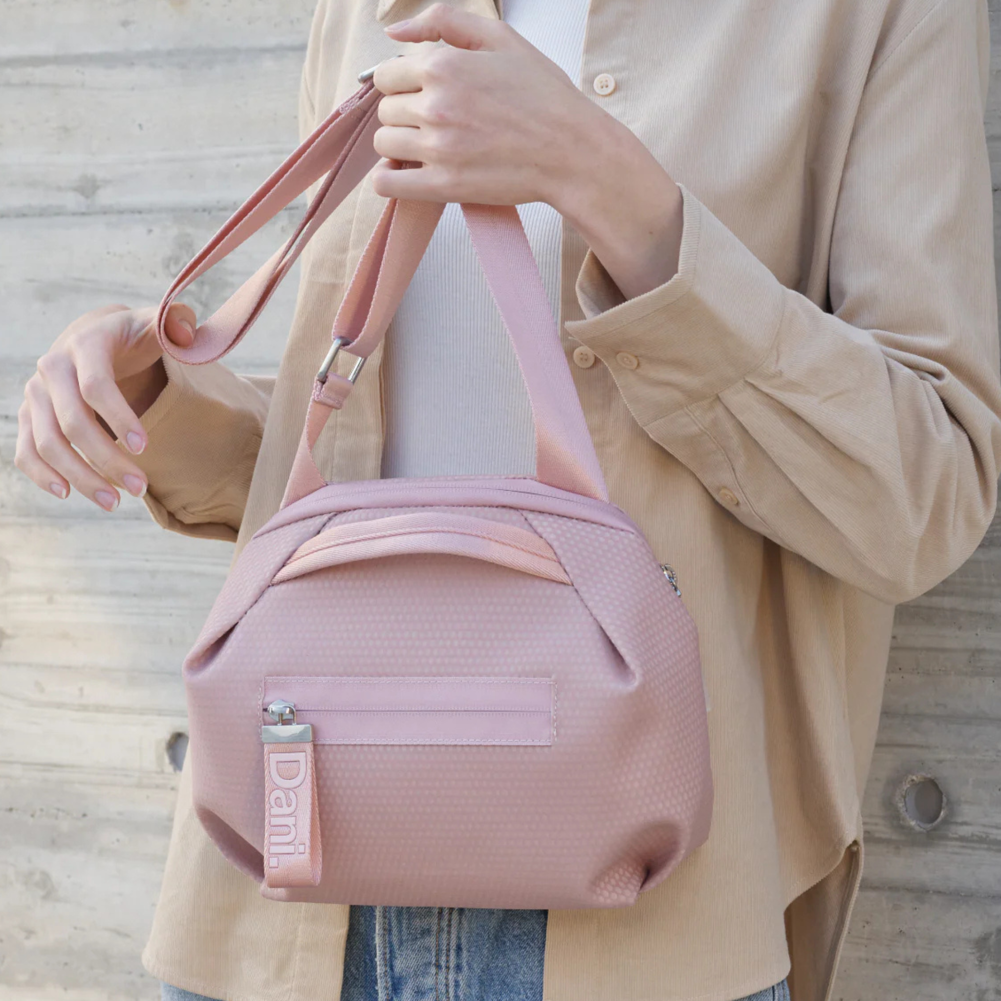 Daniella Lehavi Bonnie Crossbody bag with sleek leather design and adjustable strap, shown on a neutral background.