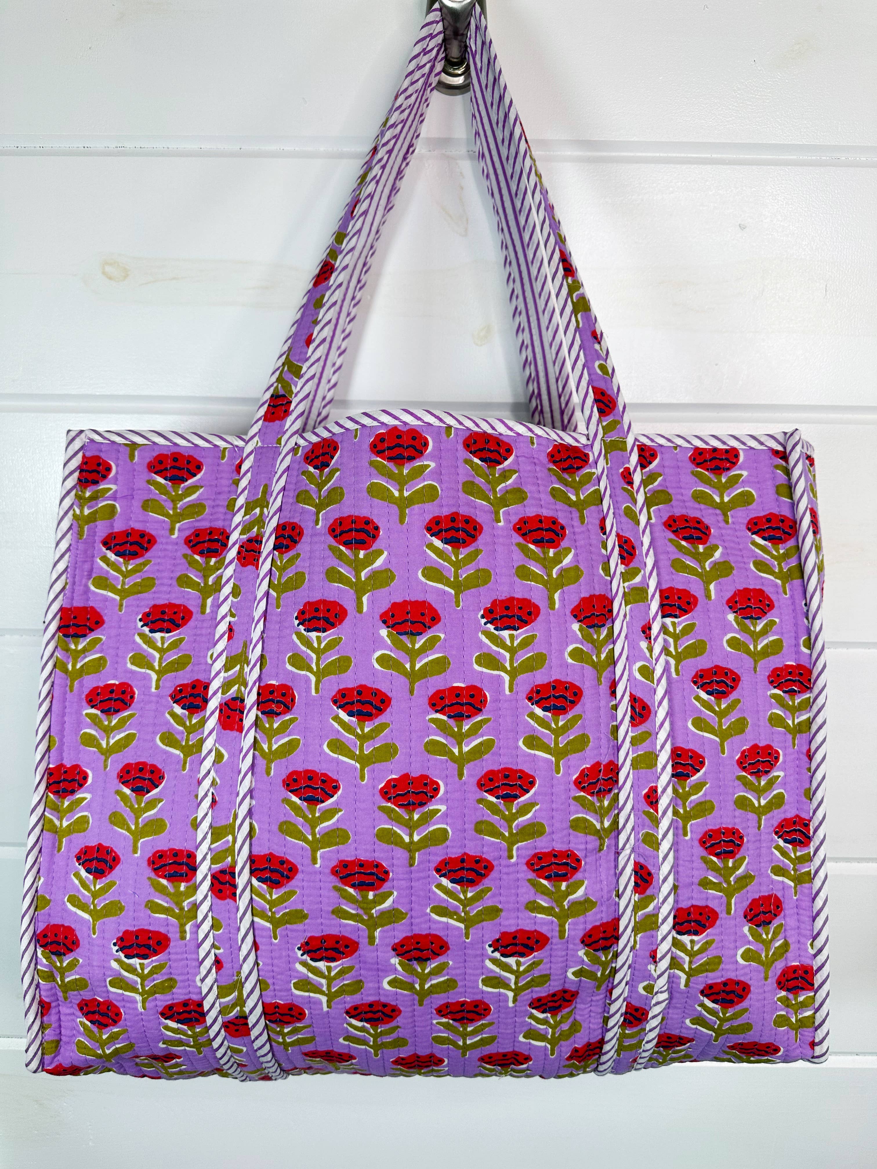 Large purple floral quilted tote bag by Folklore Couture, featuring a spacious design and elegant floral pattern.