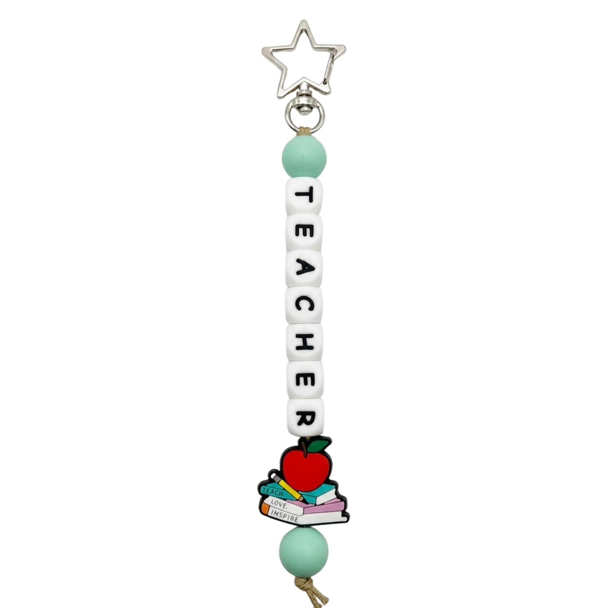 Jules by the Sea bag charms and keychains featuring colorful seaside-themed designs on a sleek keyring and charm set.