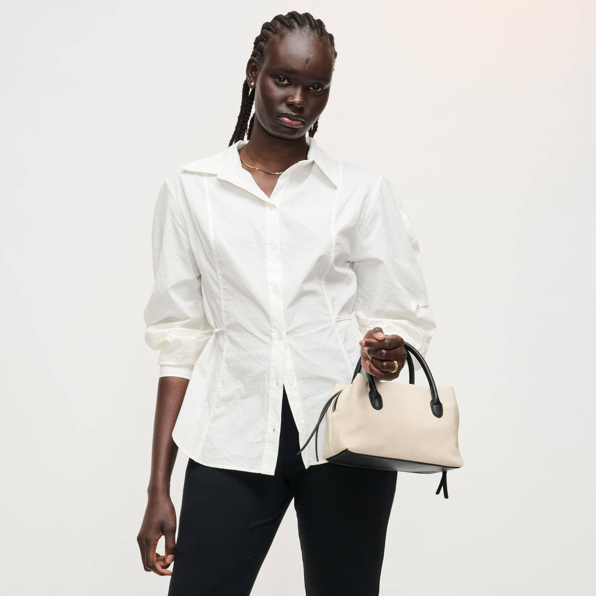 Urban Expressions Logan Crossbody bag with adjustable strap and zippered compartments, stylish accessory for everyday use.