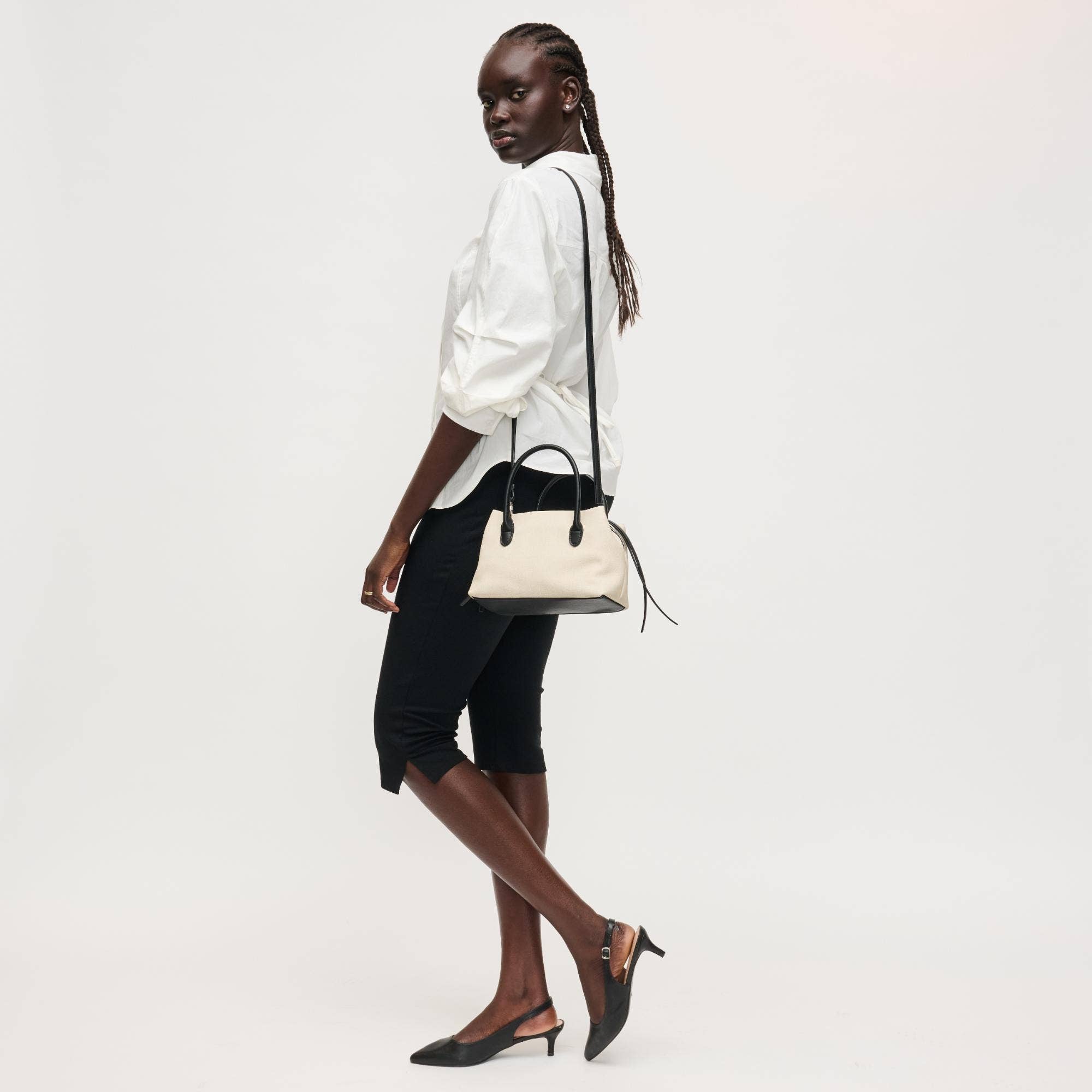 Urban Expressions Logan Crossbody bag with adjustable strap and multiple compartments, shown in tan leather.