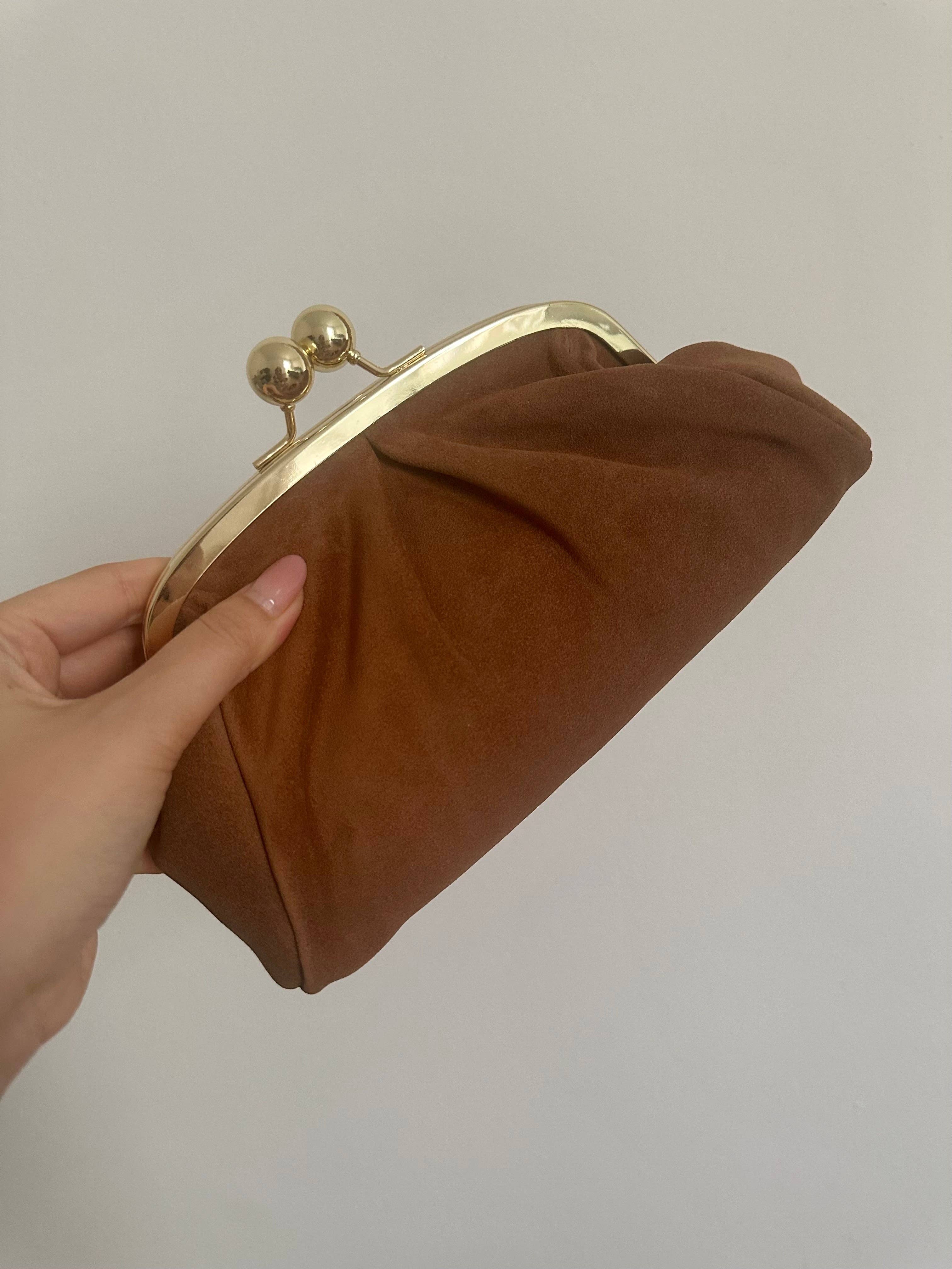 Private label frame suede clutch bag with sleek design and gold-tone clasp, shown on a neutral background.