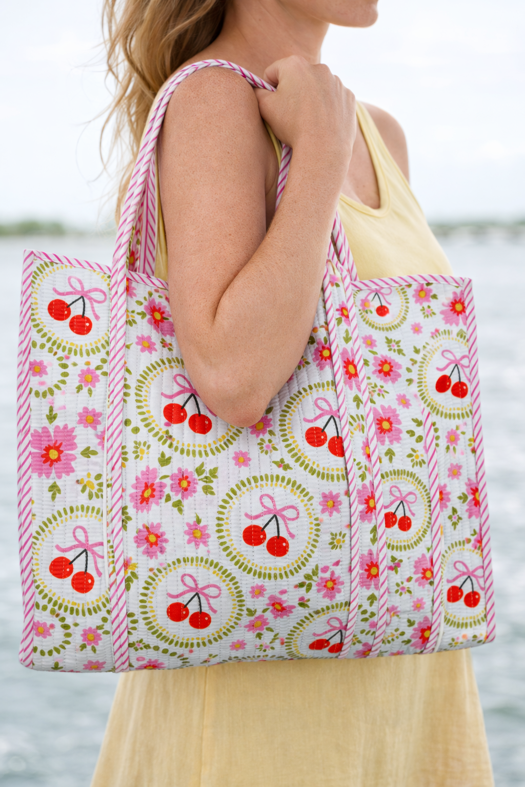 Large quilted travel tote bag by Folklore Couture in white with cherry and bow design, spacious and stylish for everyday use
