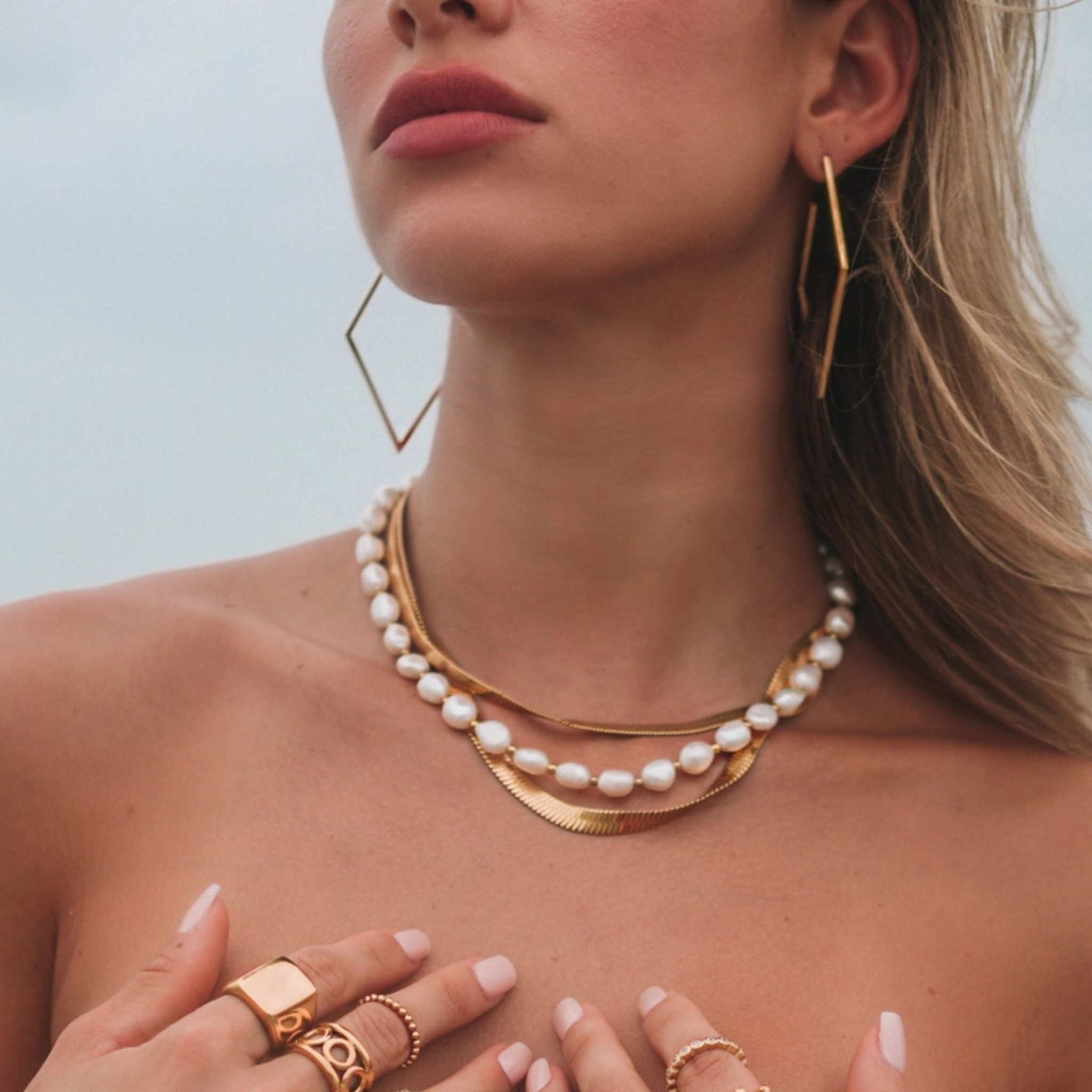 Lori Hoops earrings by Sahira Jewelry Design featuring a stylish, soft hoop design in a gold finish.