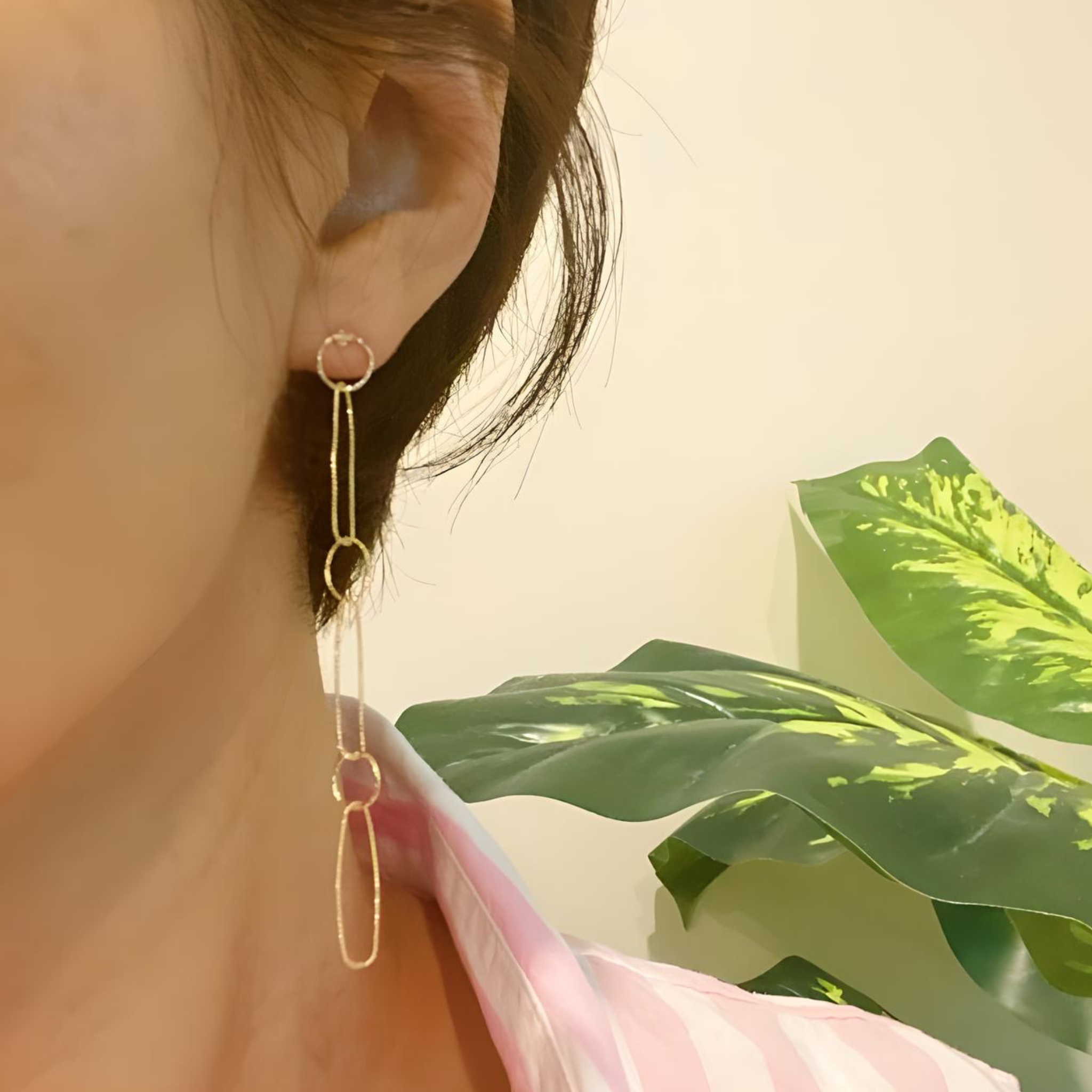 Ellison + Young dangle dainty chain earrings with delicate linked chain design hanging from ear lobe.