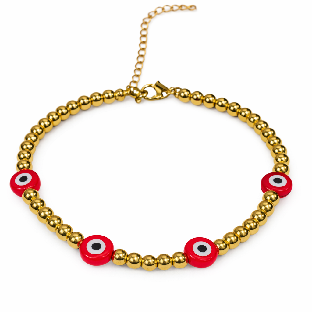 Gold beaded evil eye bracelet by The Skylar Project featuring red evil eye beads on a white background.