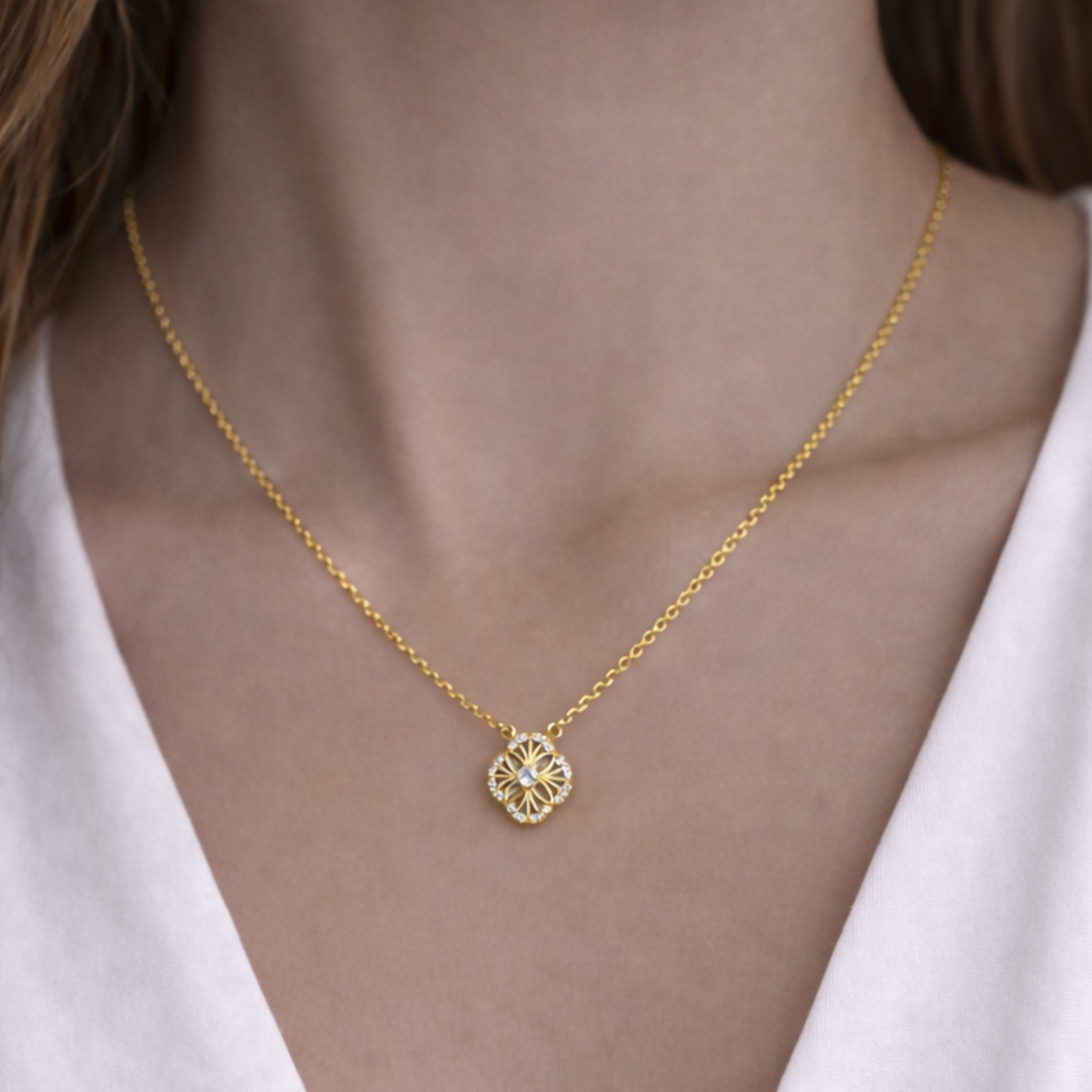 Gold mini medallion necklace with delicate pendant worn by a person in a white top, elegant jewelry by Private Label.
