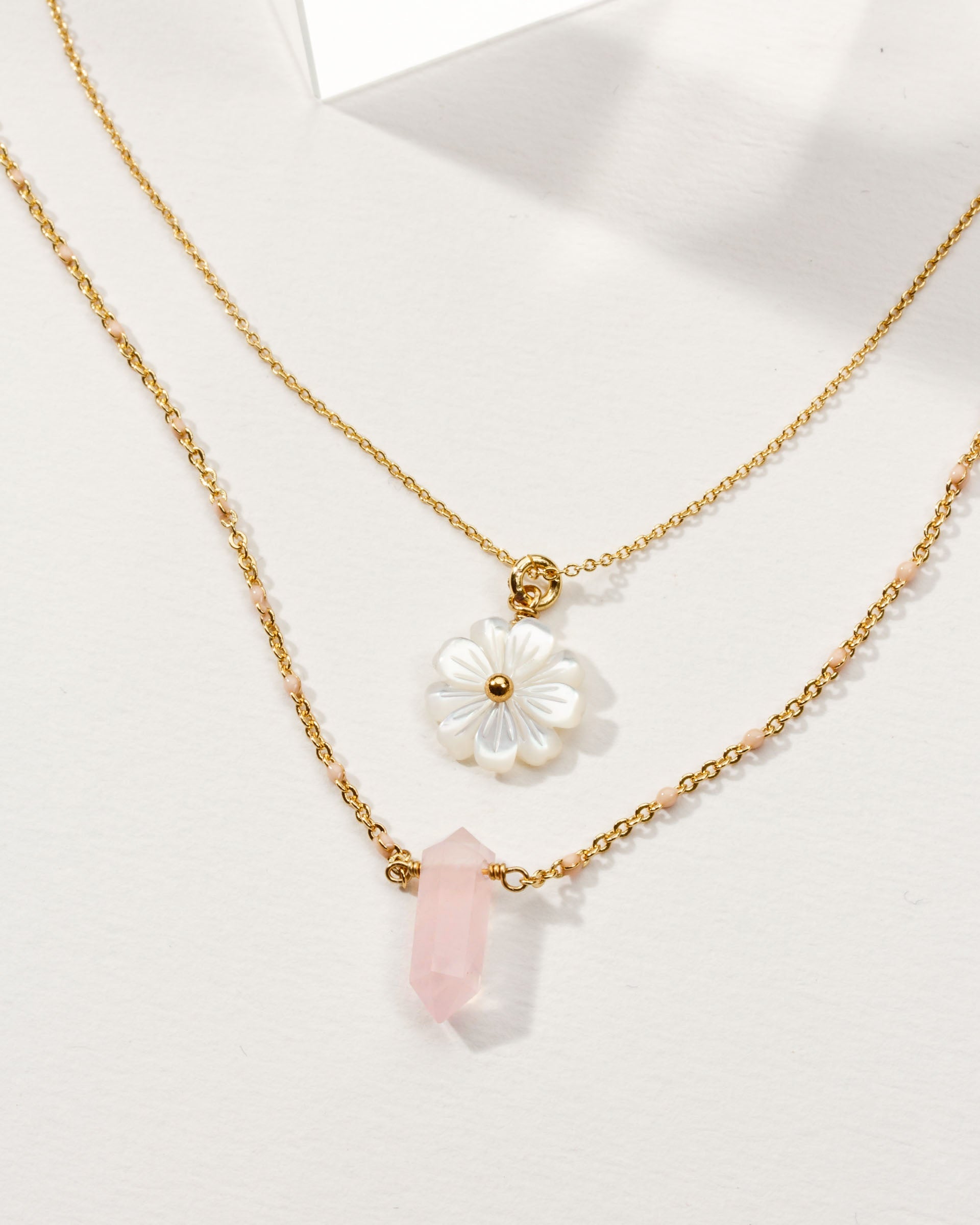 Luna Norte Blooming Crystal layered necklace set with rose quartz stones, featuring delicate chains and a floral-inspired design.