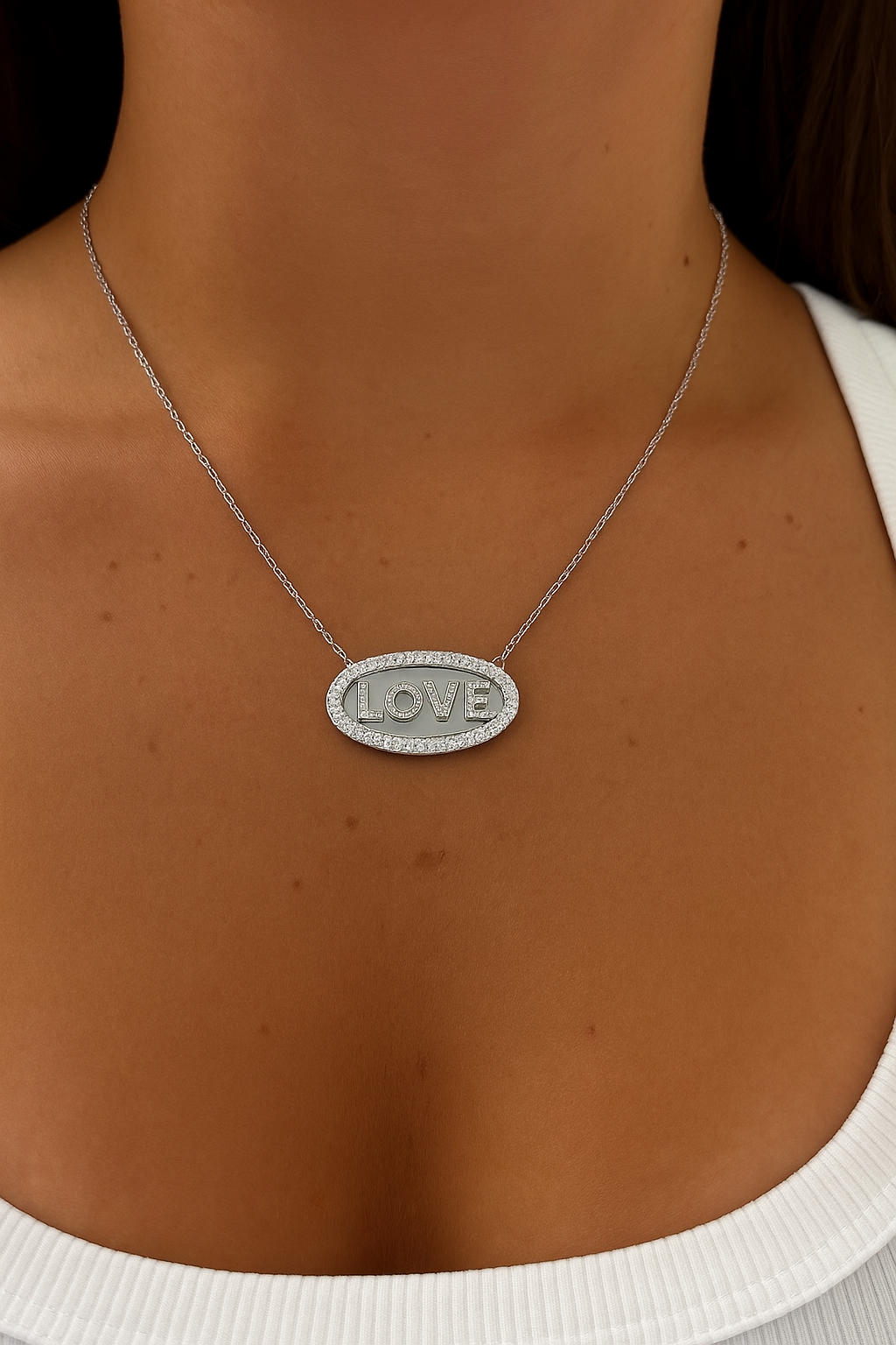 Sterling silver 925 Love oval disk necklace by Private Label Jewelry with a polished finish and delicate chain.
