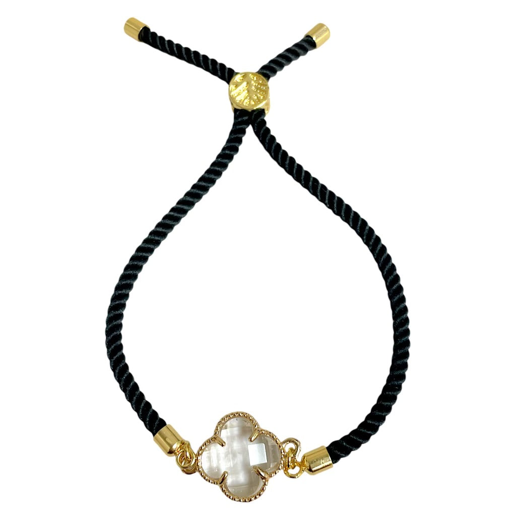 Brenda Perruzza Jewelry rope pulley bracelet with adjustable cord and decorative metal accents on a neutral background.
