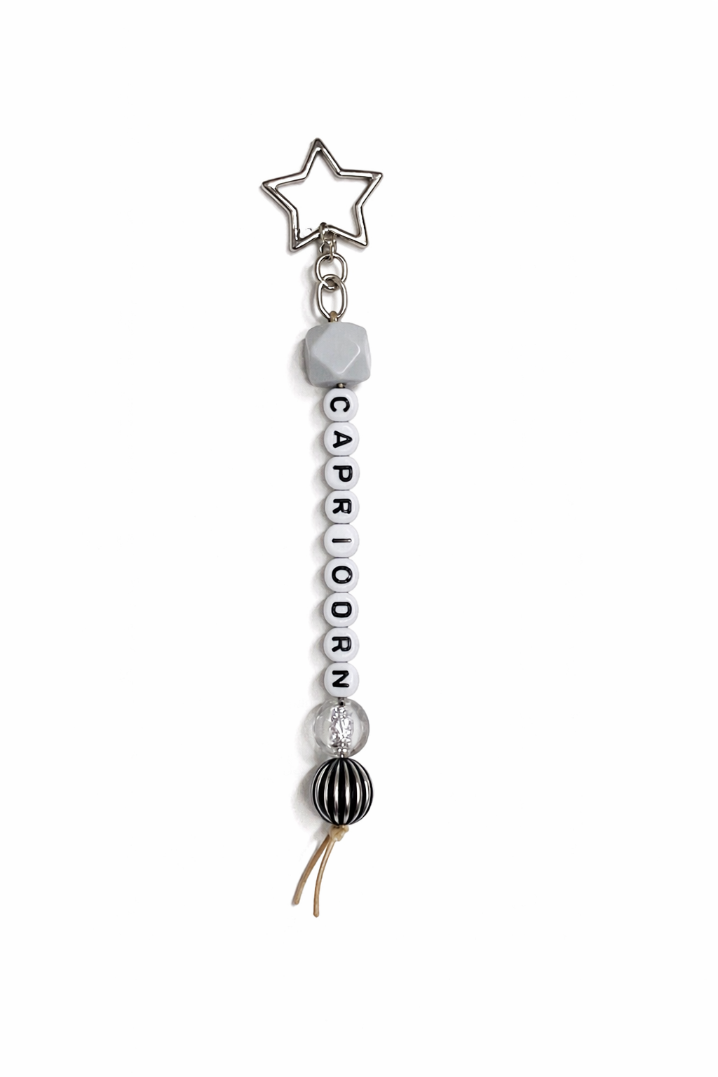 Jules by the Sea Zodiac keychain featuring a circular pendant with zodiac symbols on a silver-tone keychain.