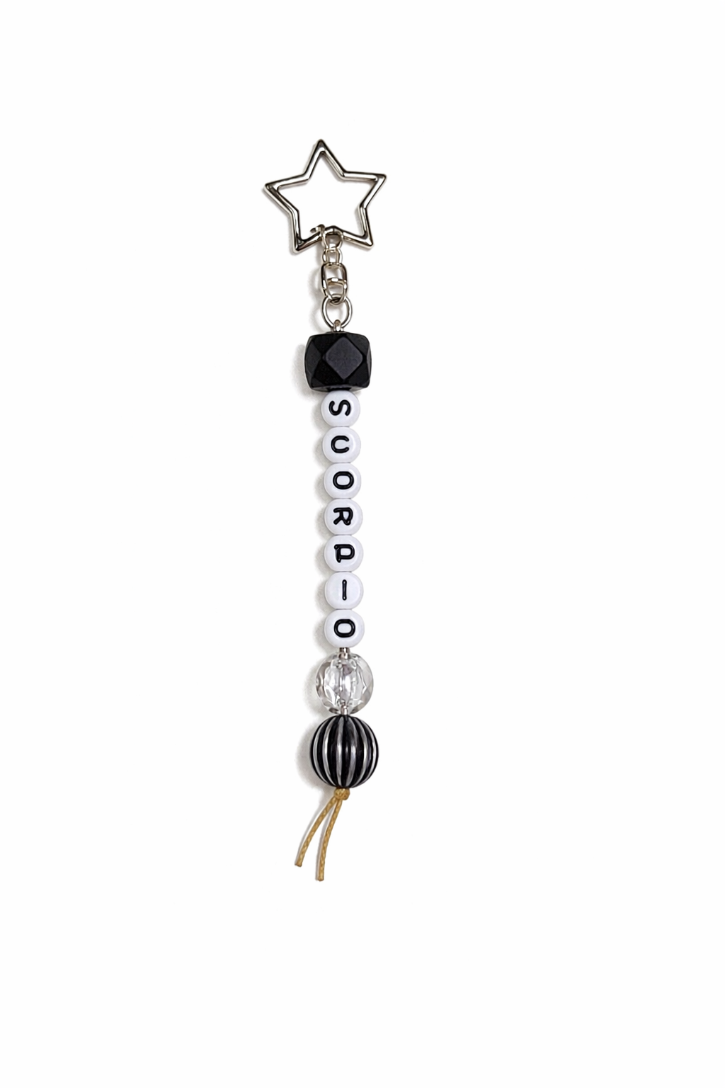 Jules by the Sea Zodiac keychain featuring a celestial design with zodiac symbols on a metal keychain.