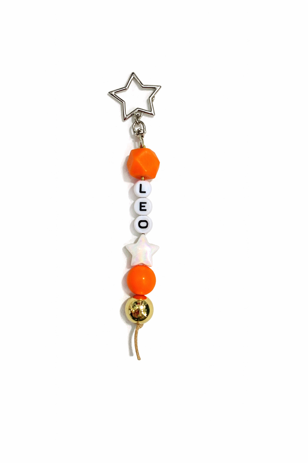 Jules by the Sea Zodiac keychain with a celestial design and metallic finish, attached to a keyring, showcasing astrological symbols.
