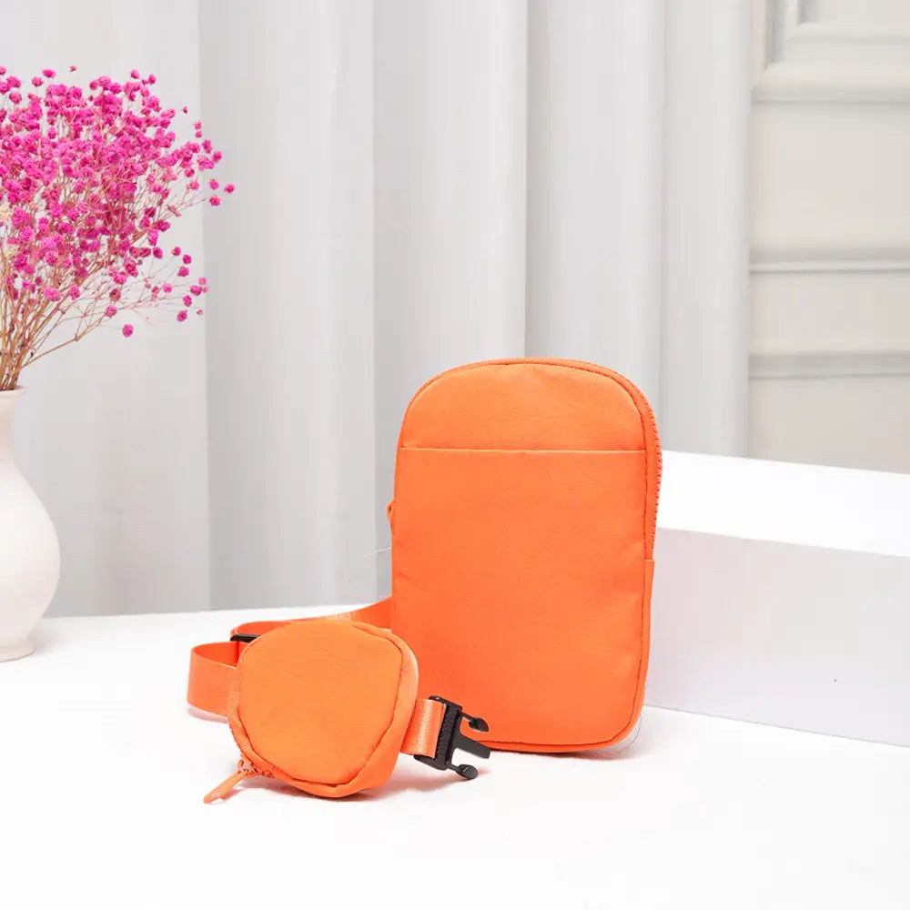 Bright orange nylon sling bag with adjustable strap and minimalist design, perfect for casual crossbody wear.