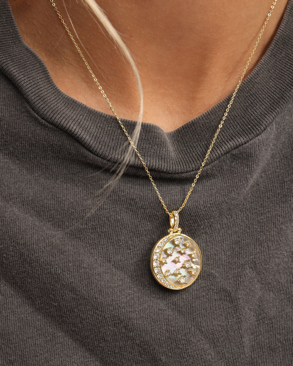 Melinda Maria Sweet Dreams Medallion necklace featuring an intricate design and elegant chain, set against a soft background.