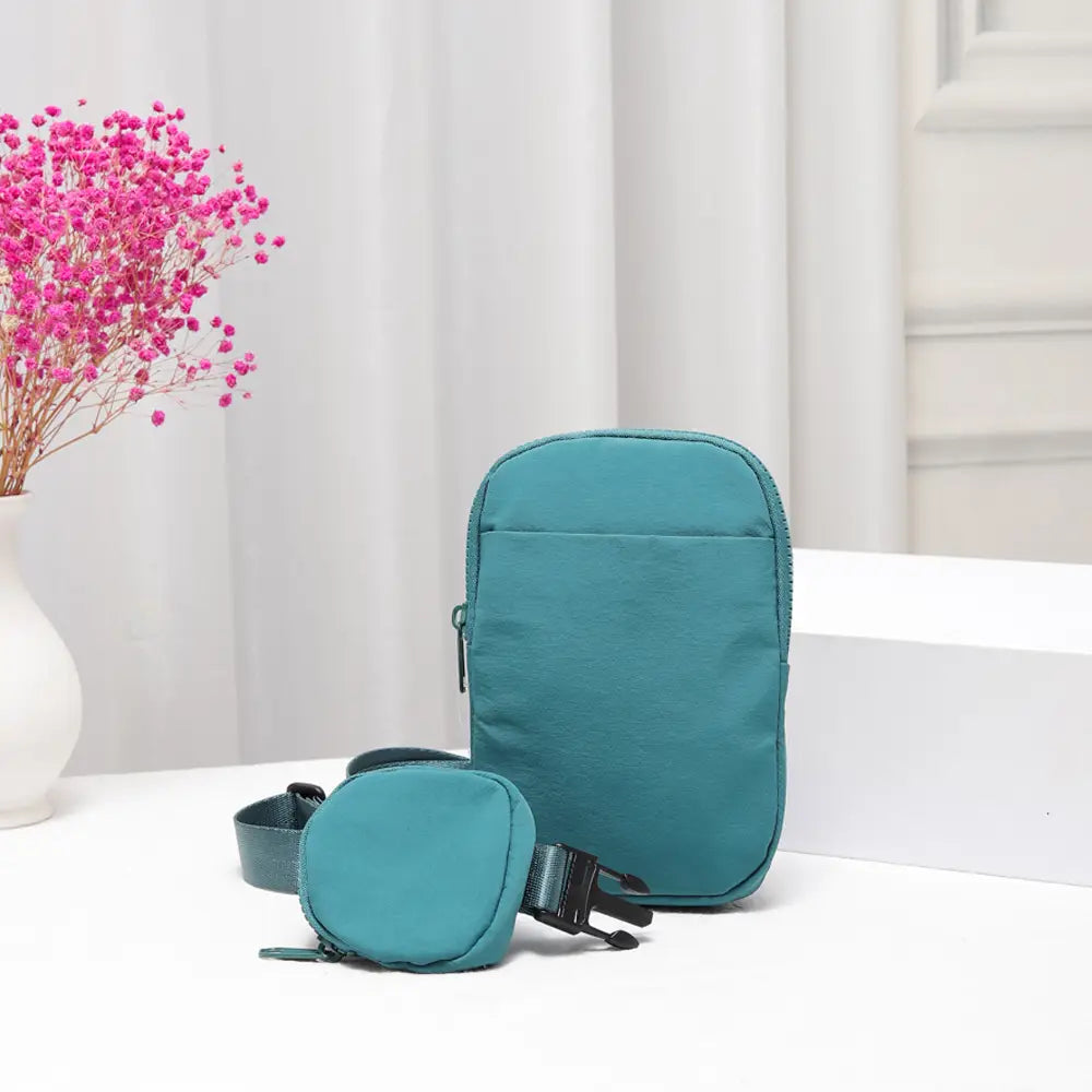 Teal nylon sling bag with adjustable strap and minimalist design, ideal for crossbody carrying by private label.