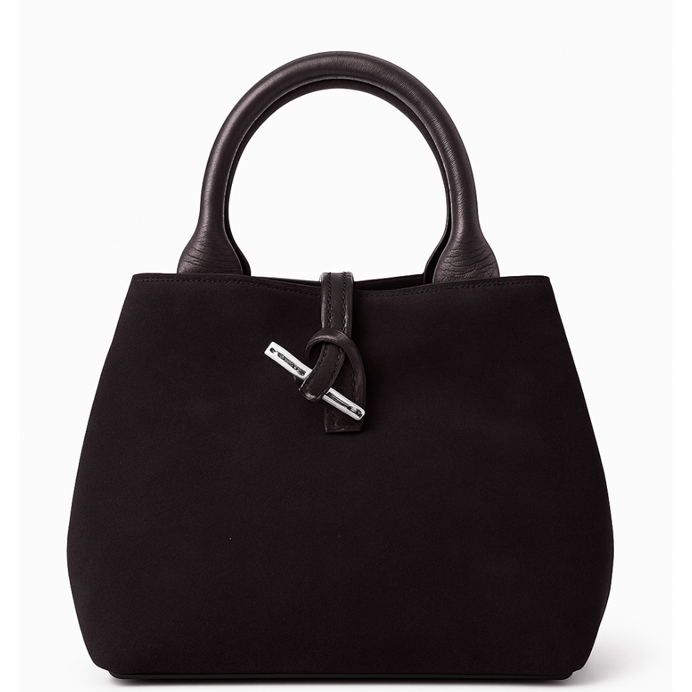 Private label suede bag called The Italy, featuring a sleek design with a top handle and minimal detailing.