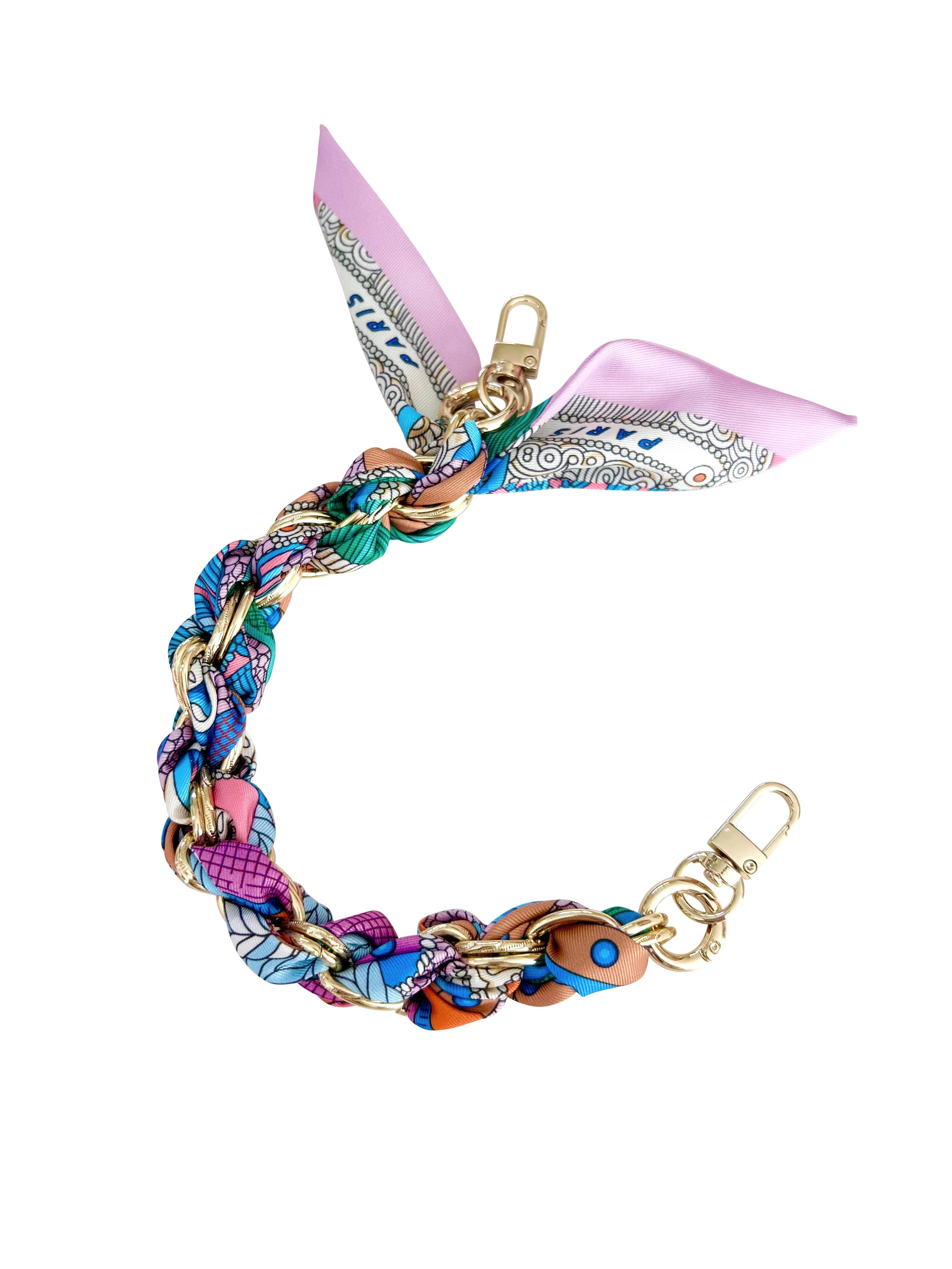 Gold phone chain by Gemelli featuring a vibrant colorful paisley print design.