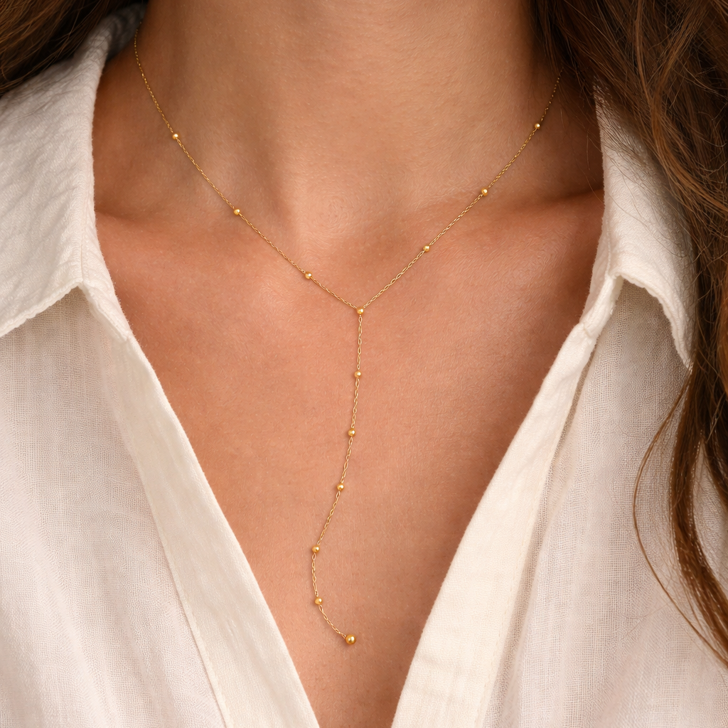 Elegant Brisse 18K gold non-tarnish beaded Y-lariat necklace featuring intricate detailing and a stylish dressy design.