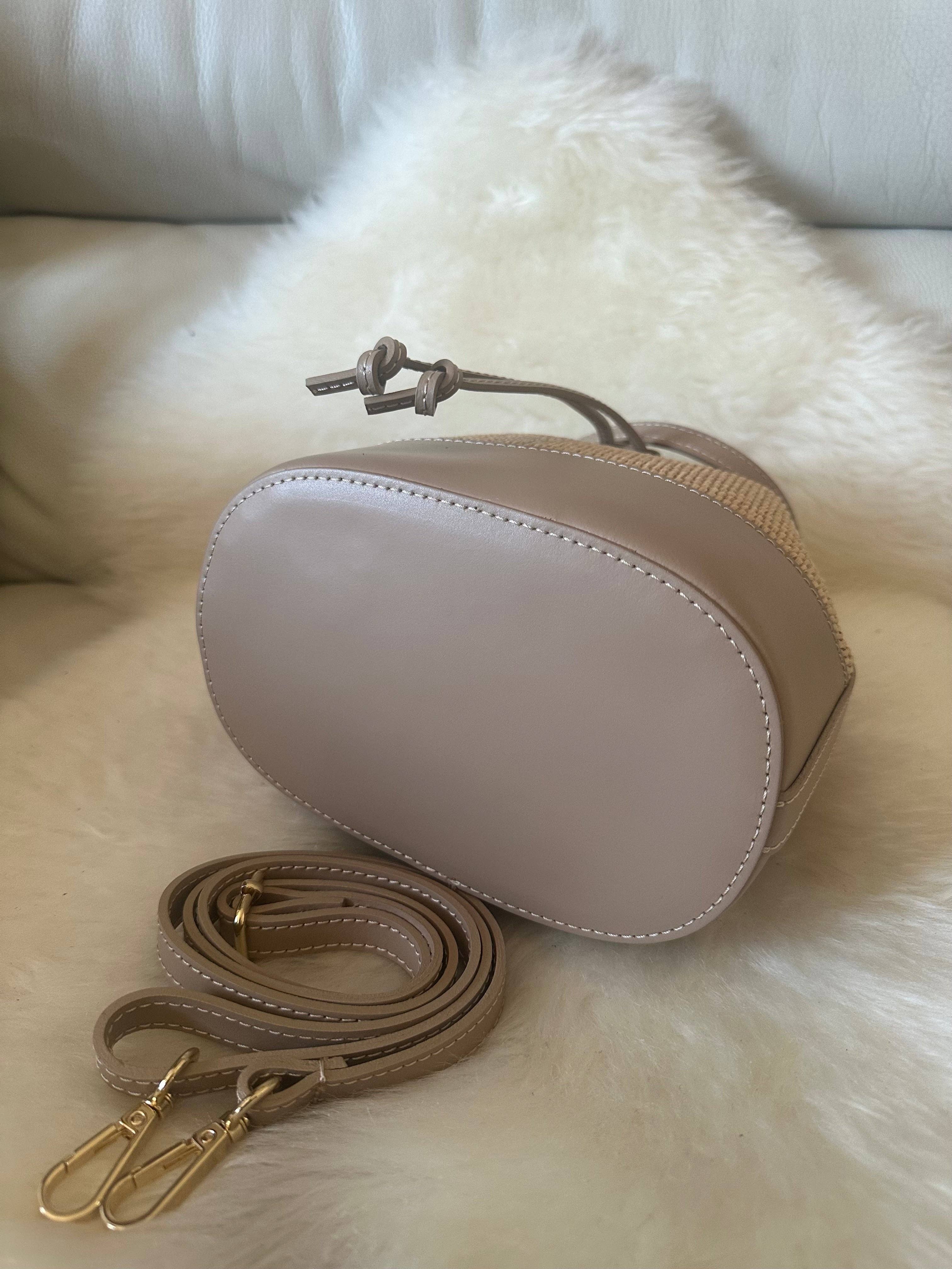 Private label MISS Bucket classic raffia crossbody bag with woven raffia material and adjustable strap.