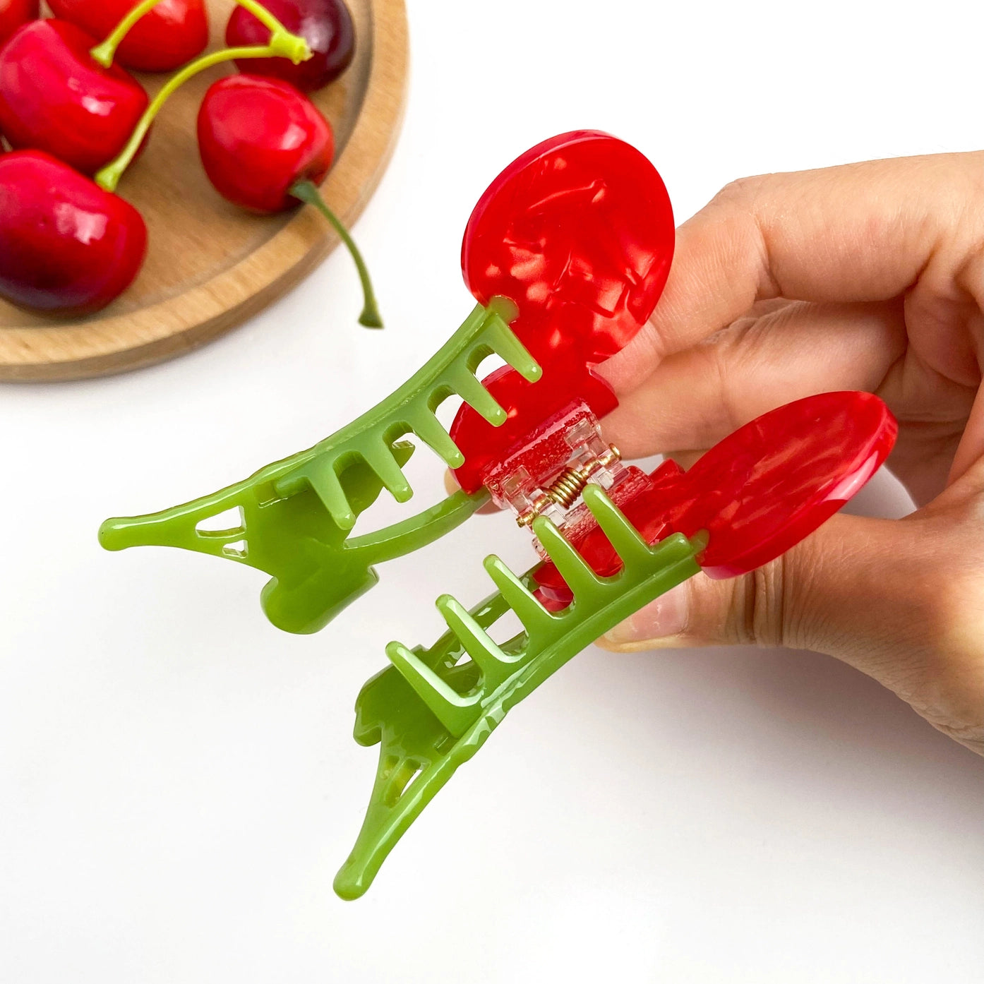 Private label sweet red cherry claw hair clip with twin cherry design, perfect for securing hair in a playful, stylish style.