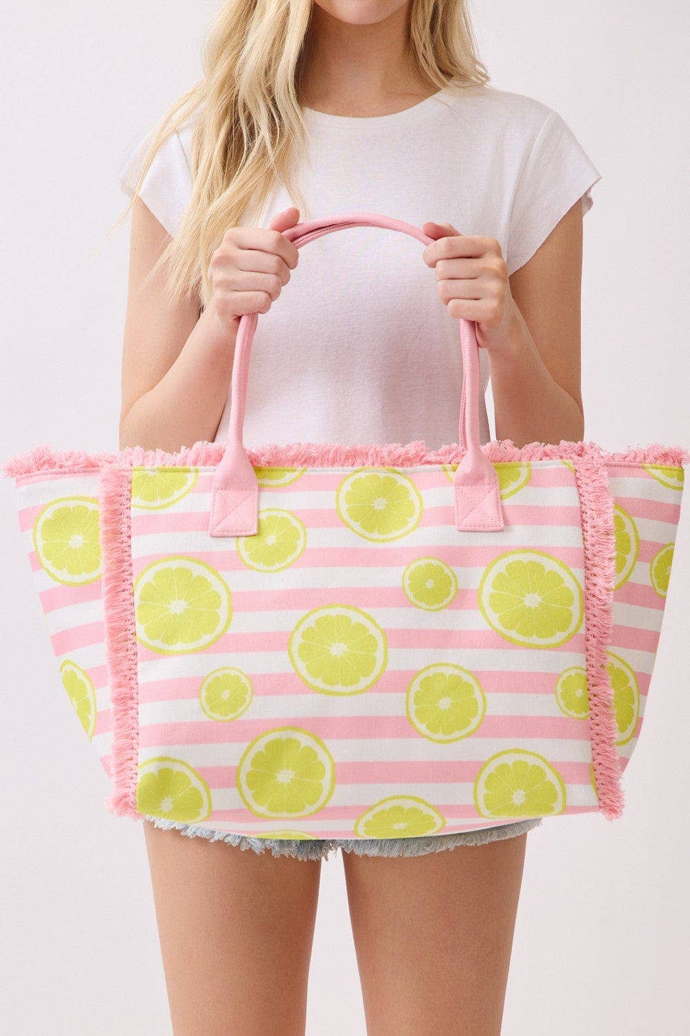 Lemon stripe fringe beach tote bag with woven handles and tassel details, perfect for summer trips and beach days.