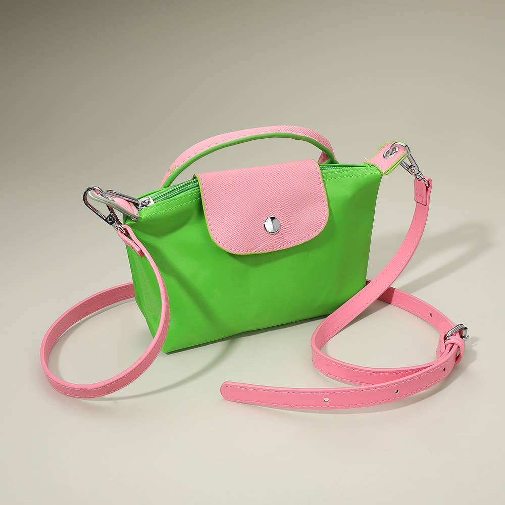 Compact two-tone handbag with adjustable strap, featuring a sleek design and stylish accents, by Private Label.