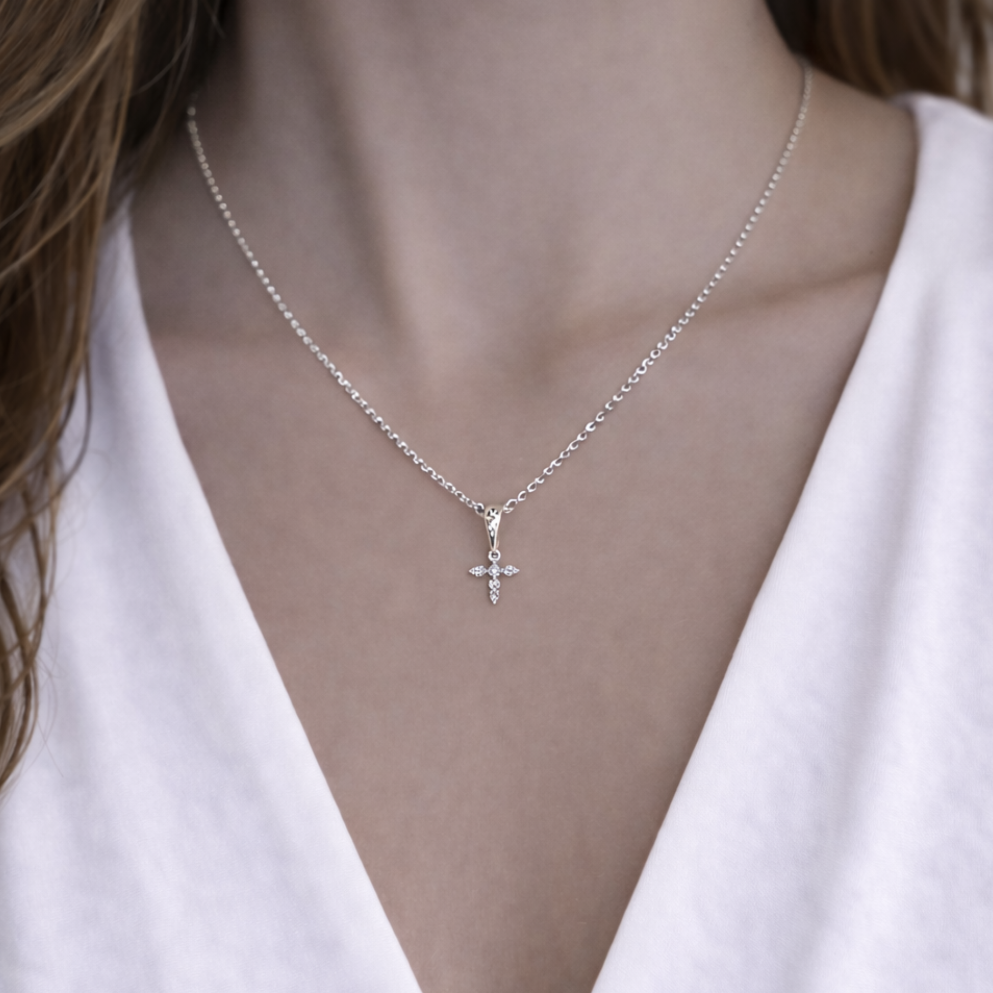 Pointed off cross necklace by Private Label featuring a sleek design with a delicate chain and unique cross pendant.