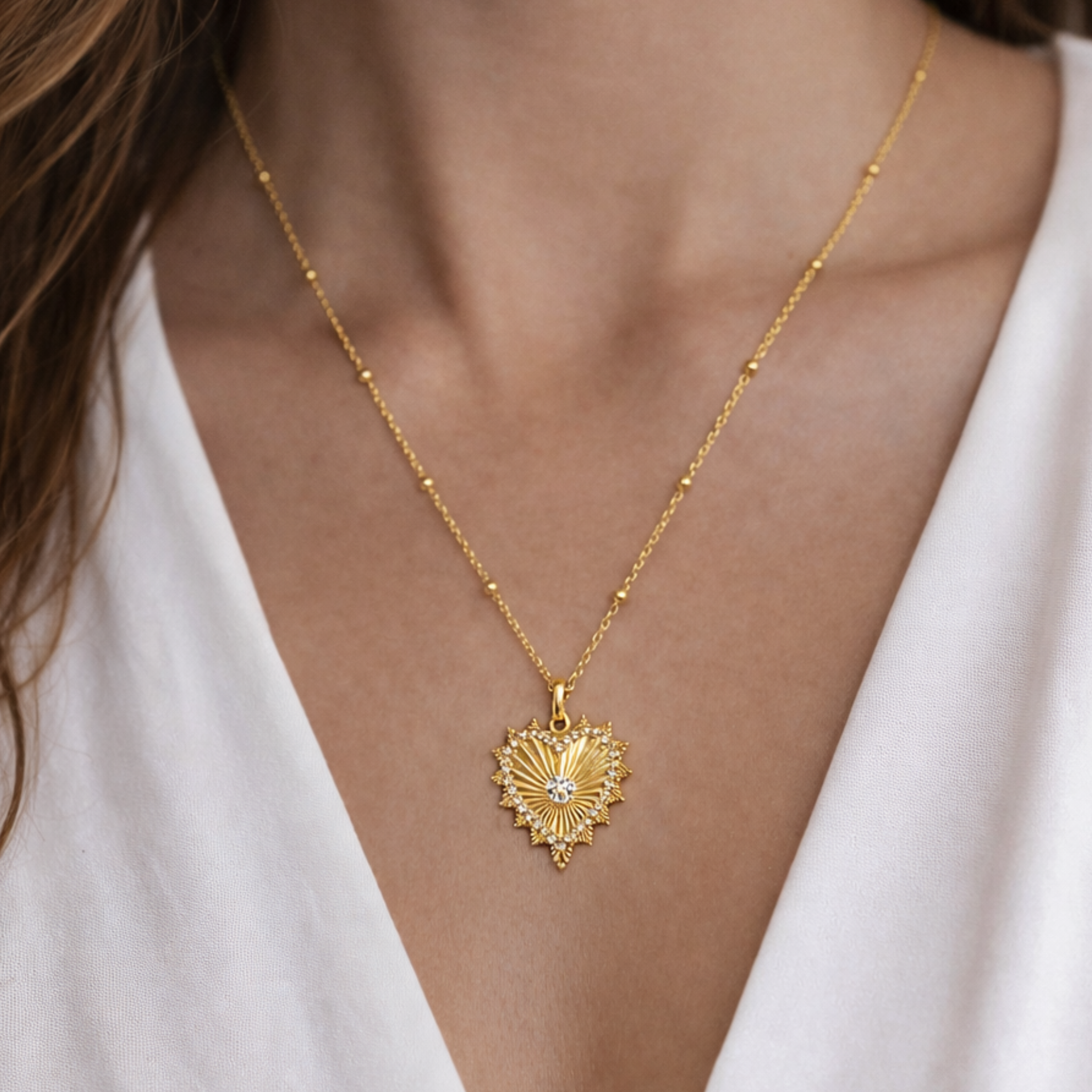 Gold heart necklace with a delicate chain and radiant heart pendant, stylish jewelry piece by Private Label.