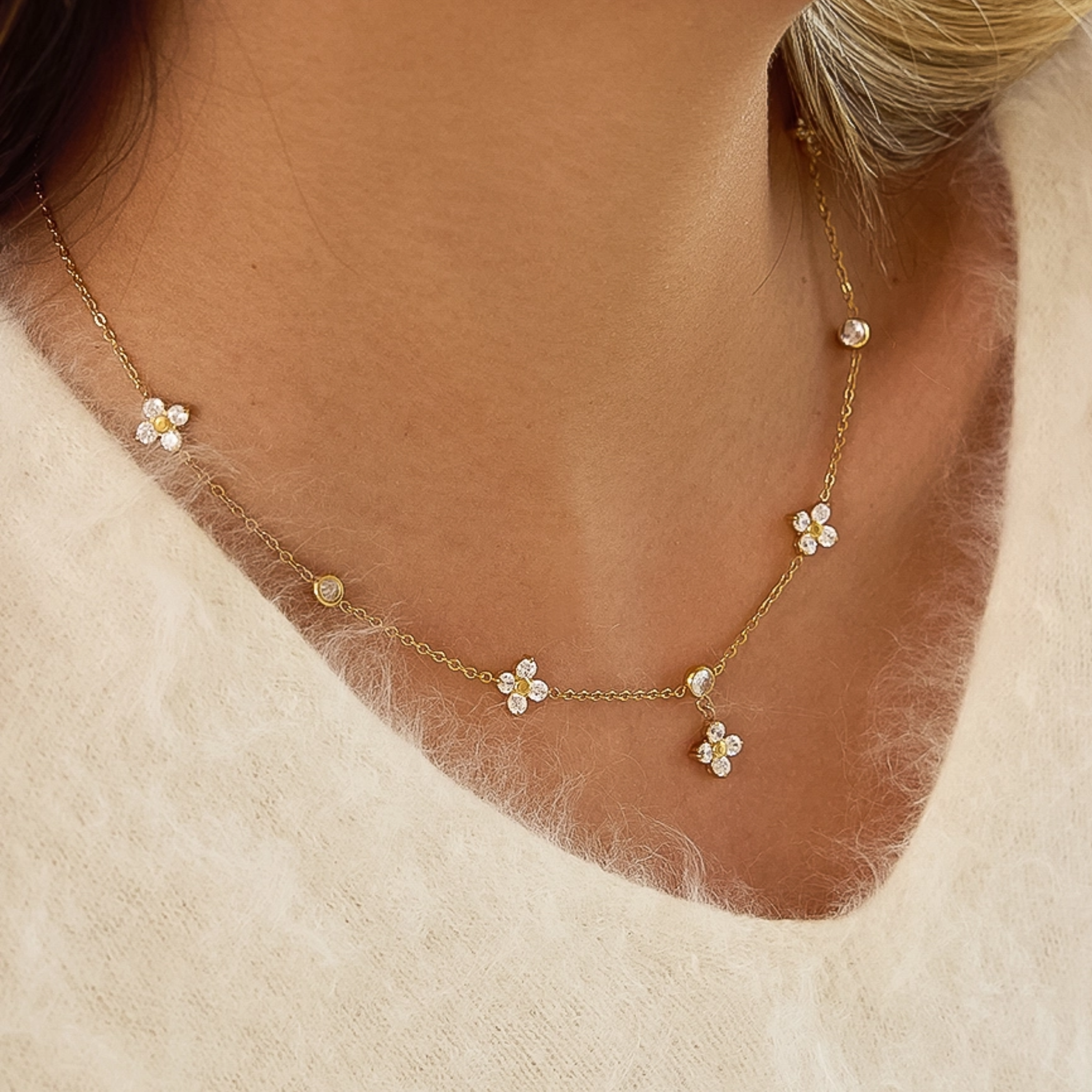 Aveline 18K gold floral chain necklace with non-tarnish CZ accents, elegantly displayed against a neutral background.