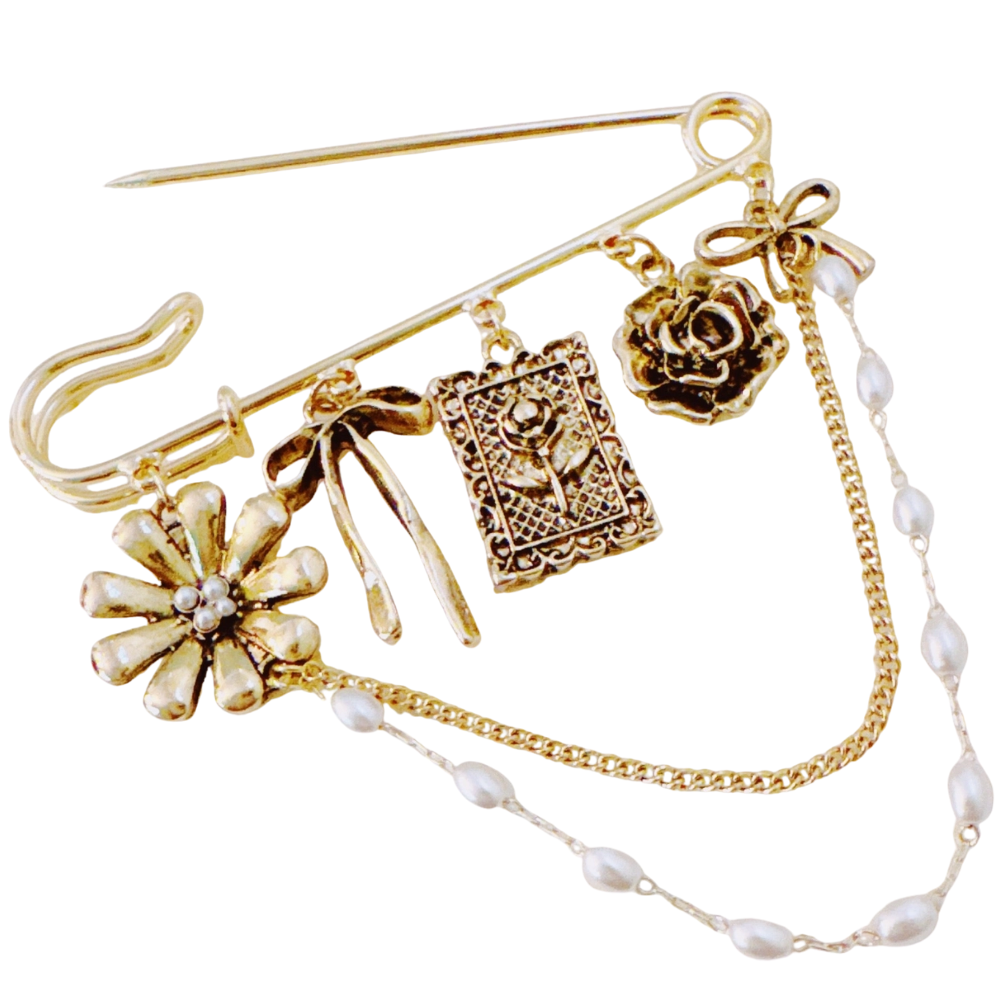 Elegant floral ribbon brooch by Ellison + Young featuring gold safety pin, charms, and pearl chains on a decorative background.