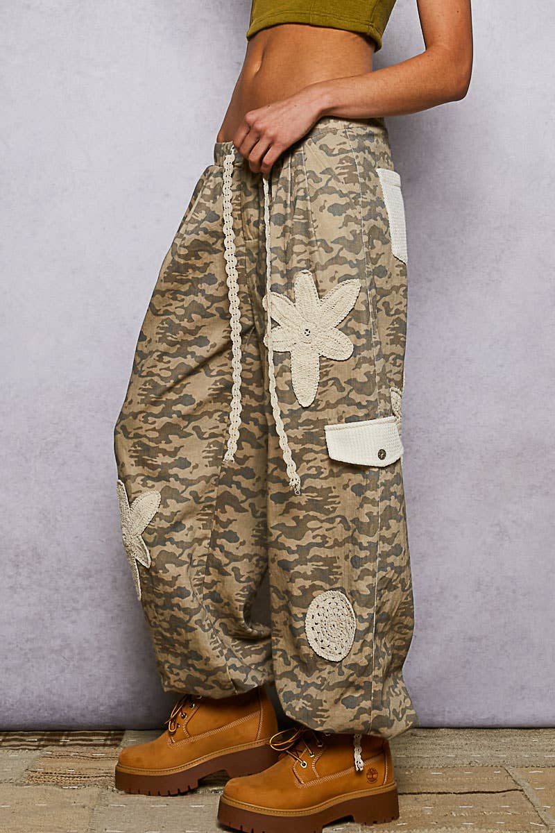Pol Clothing pleat detail floral patchwork cargo pants showing vibrant floral patches and pleated design on casual pants.