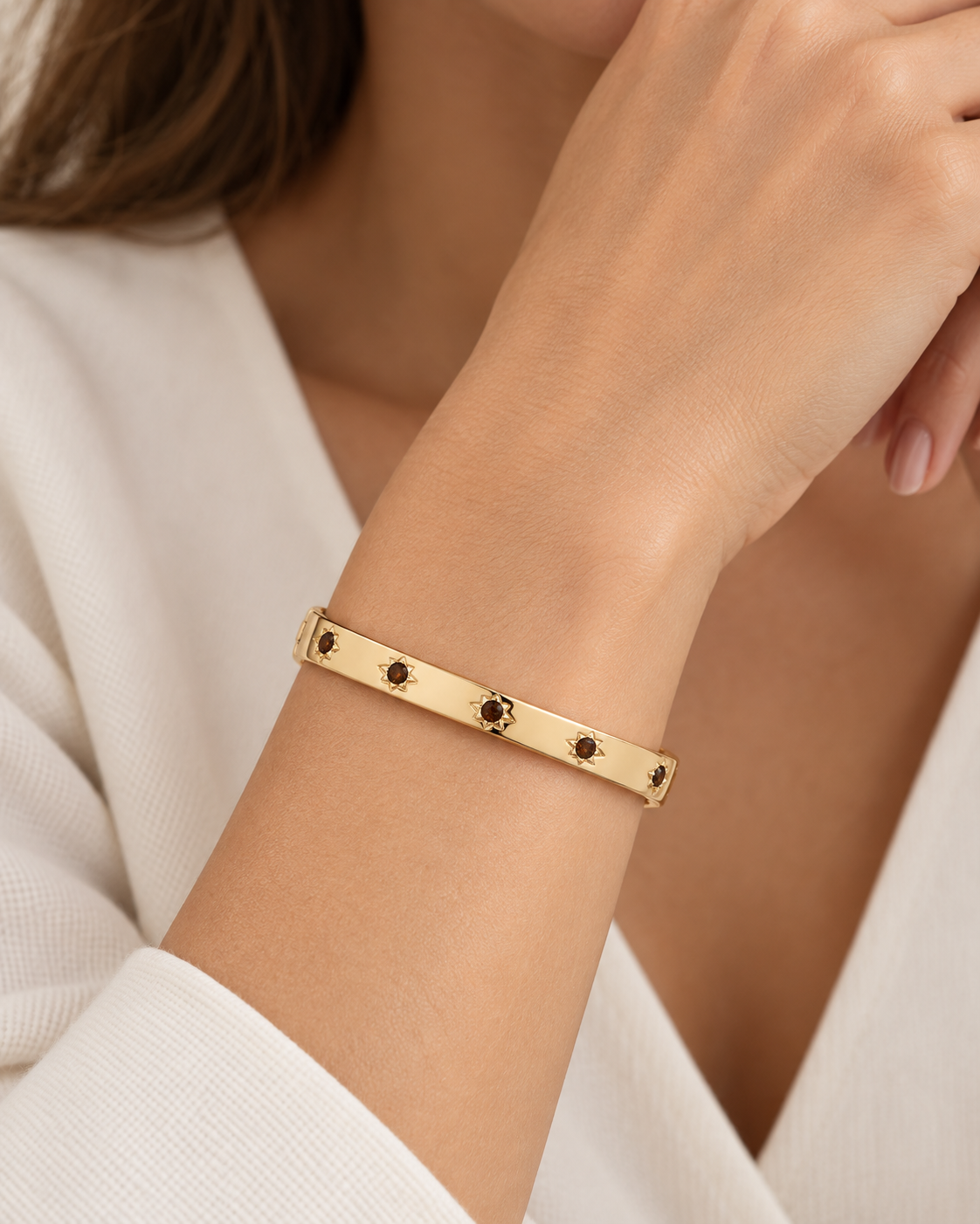 Marlyn Schiff crystal starburst hinged bangle with sparkling starburst design and shiny metal finish.